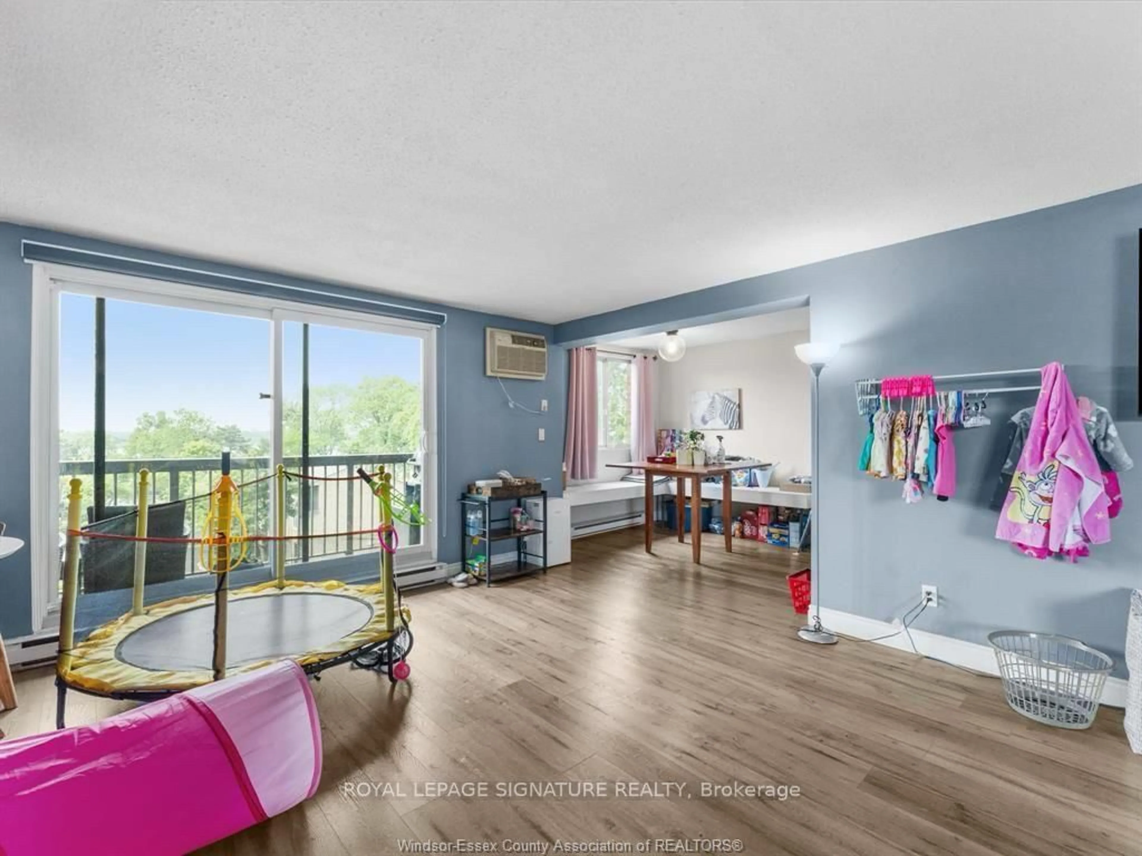 Living room with furniture, wood/laminate floor for 3936 Wyandotte St #503, Windsor Ontario N8Y 4V1