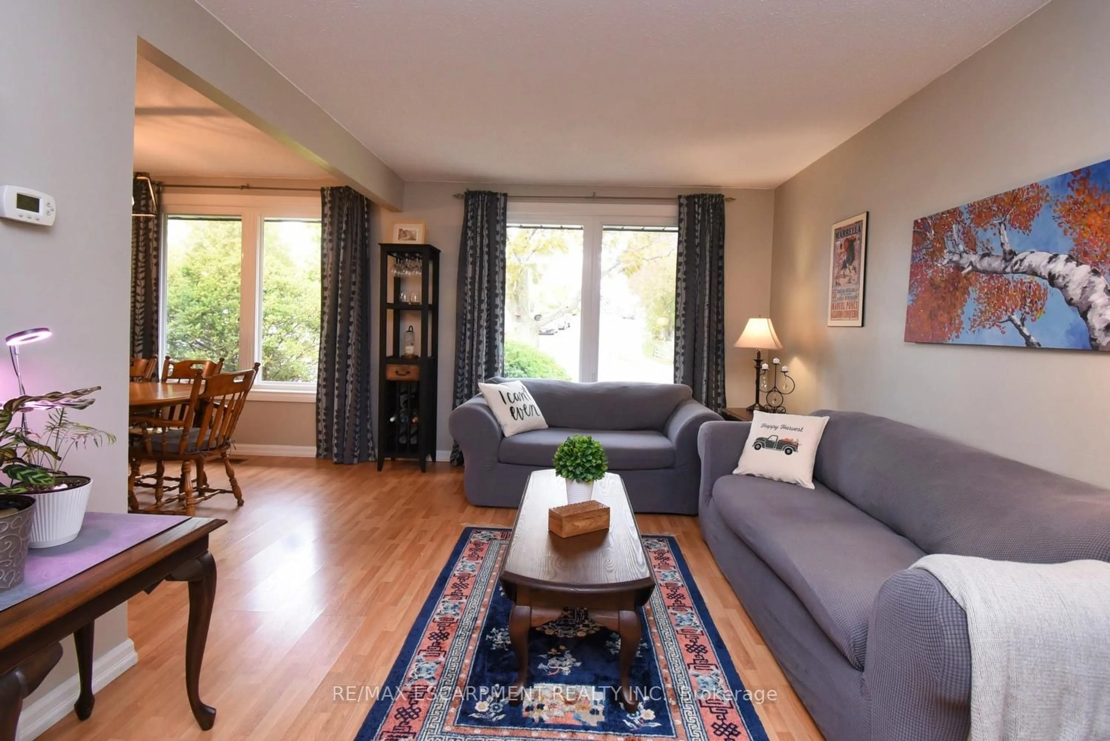 Living room with furniture, wood/laminate floor for 119 Gemini Dr, Hamilton Ontario L9C 6C5