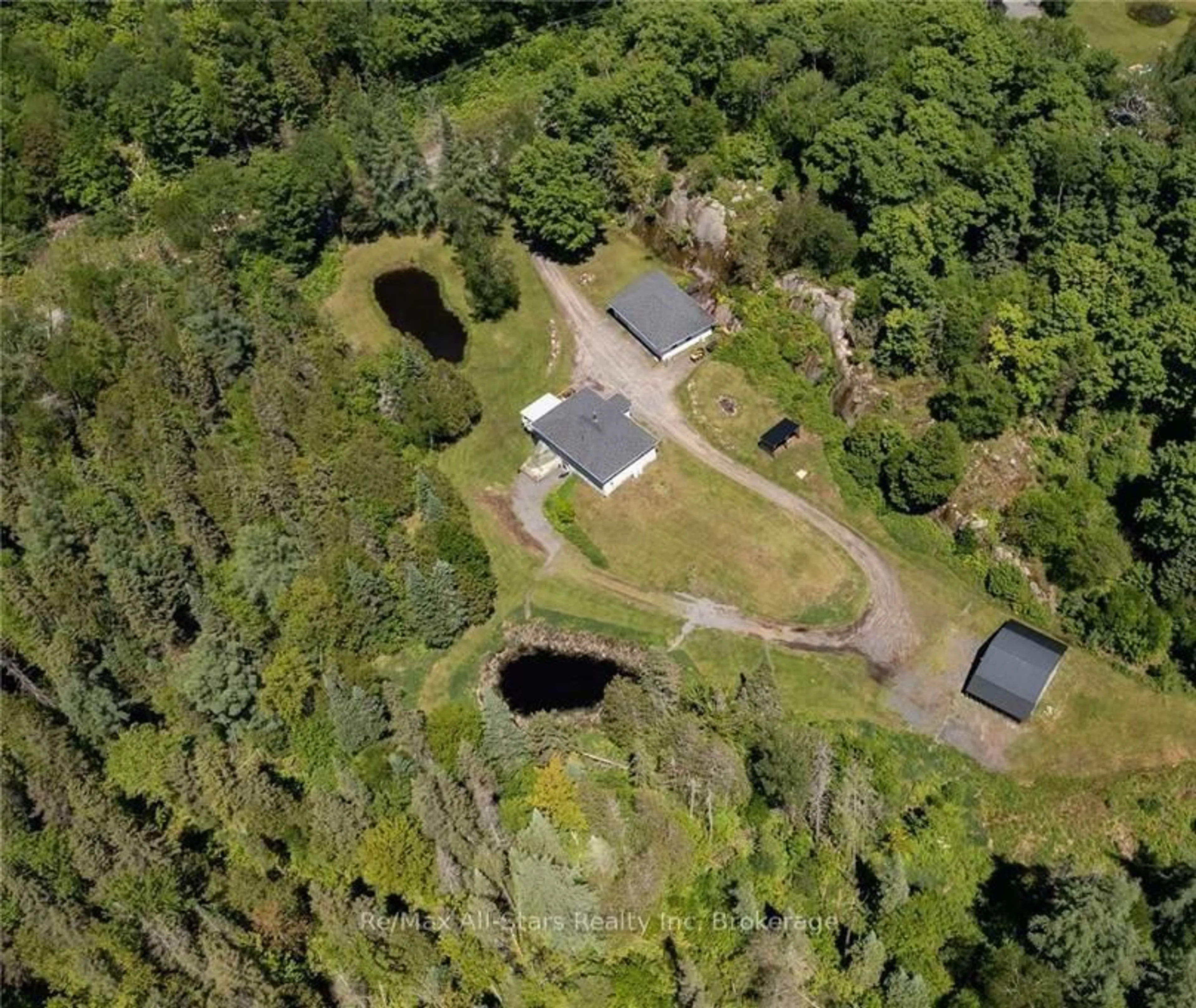 A pic from outside/outdoor area/front of a property/back of a property/a pic from drone, forest/trees view for 410 Etwell Rd, Huntsville Ontario P1H 2J2