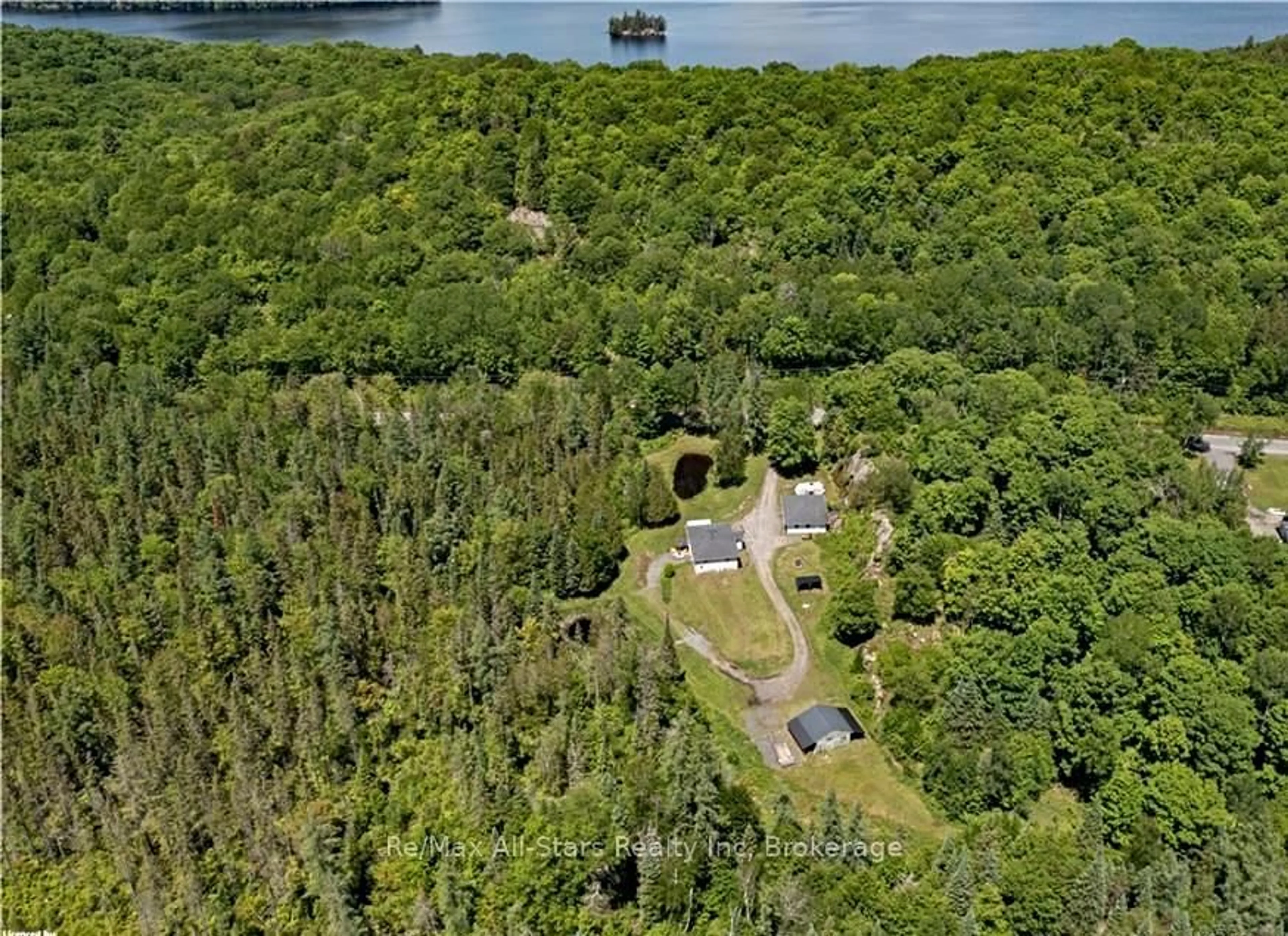 A pic from outside/outdoor area/front of a property/back of a property/a pic from drone, water/lake/river/ocean view for 410 Etwell Rd, Huntsville Ontario P1H 2J2