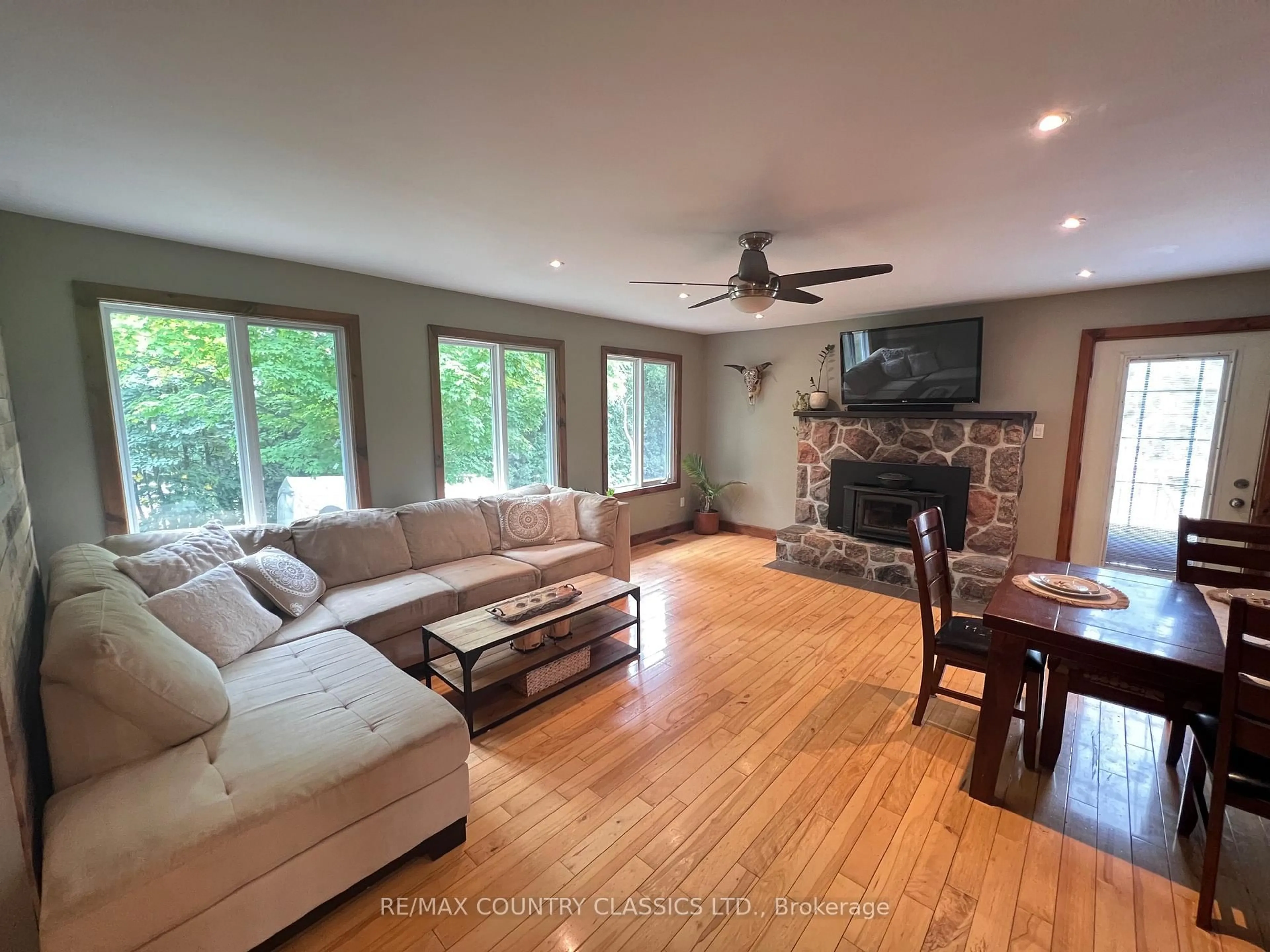 Living room with furniture, wood/laminate floor for 86 Scriven Rd, Otonabee-South Monaghan Ontario K0L 1B0