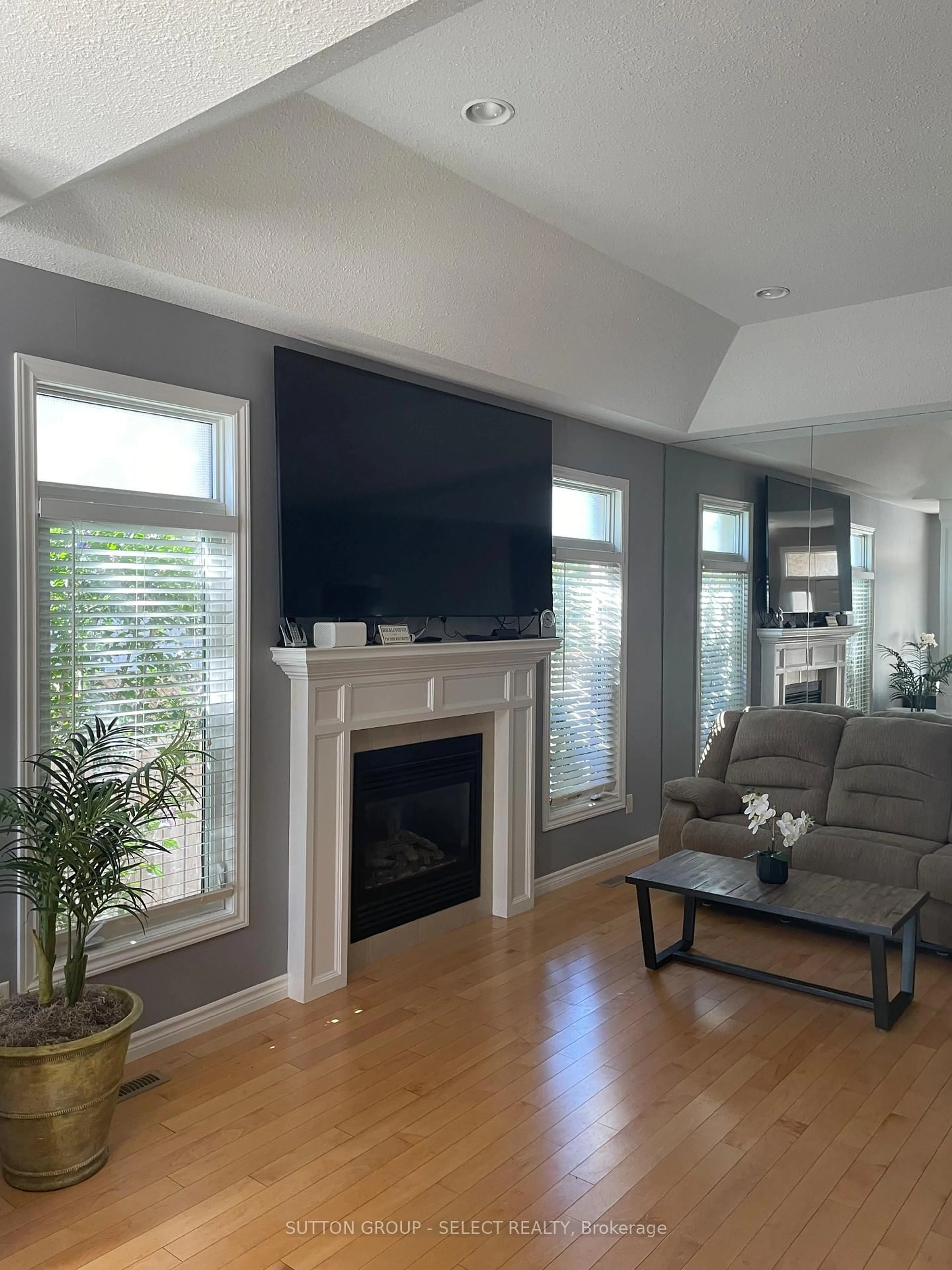 Living room with furniture, wood/laminate floor for 3220 Meadowgate Blvd, London South Ontario N6M 0B7