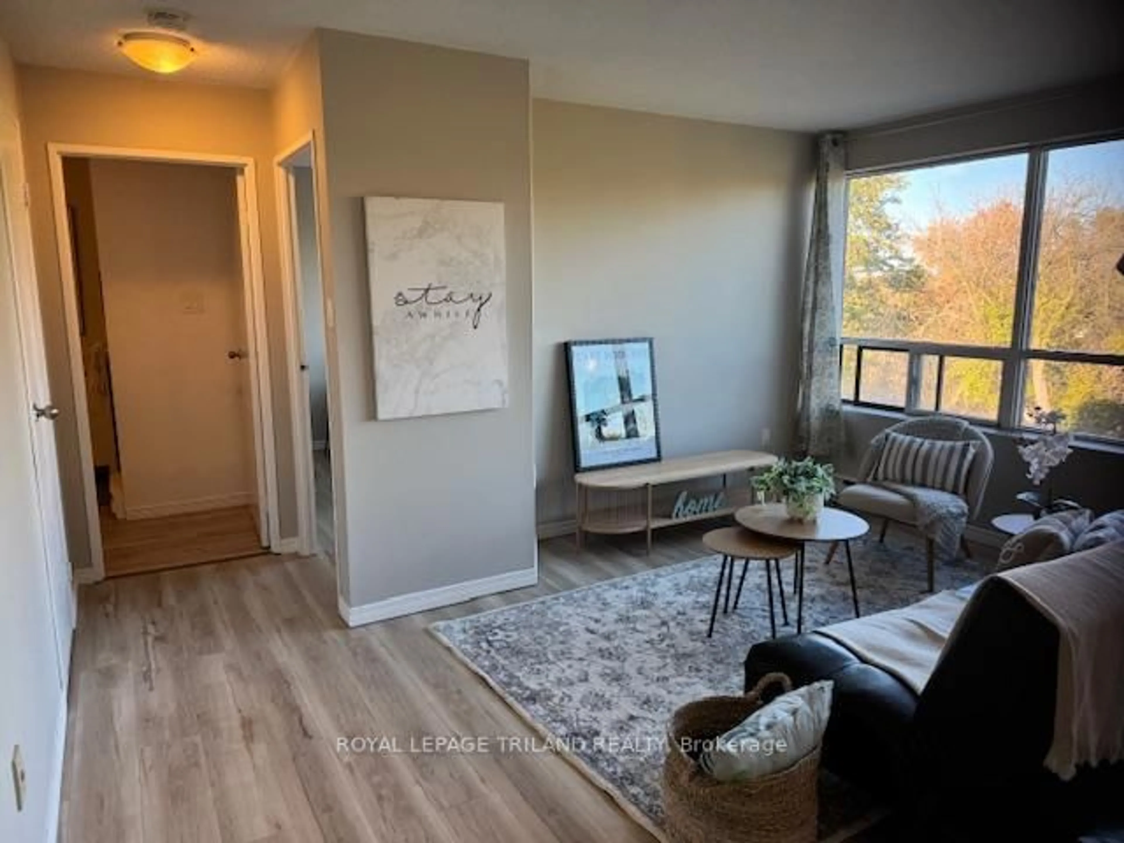 Living room with furniture, wood/laminate floor for 650 Cheapside St #605, London East Ontario N5Y 5J8