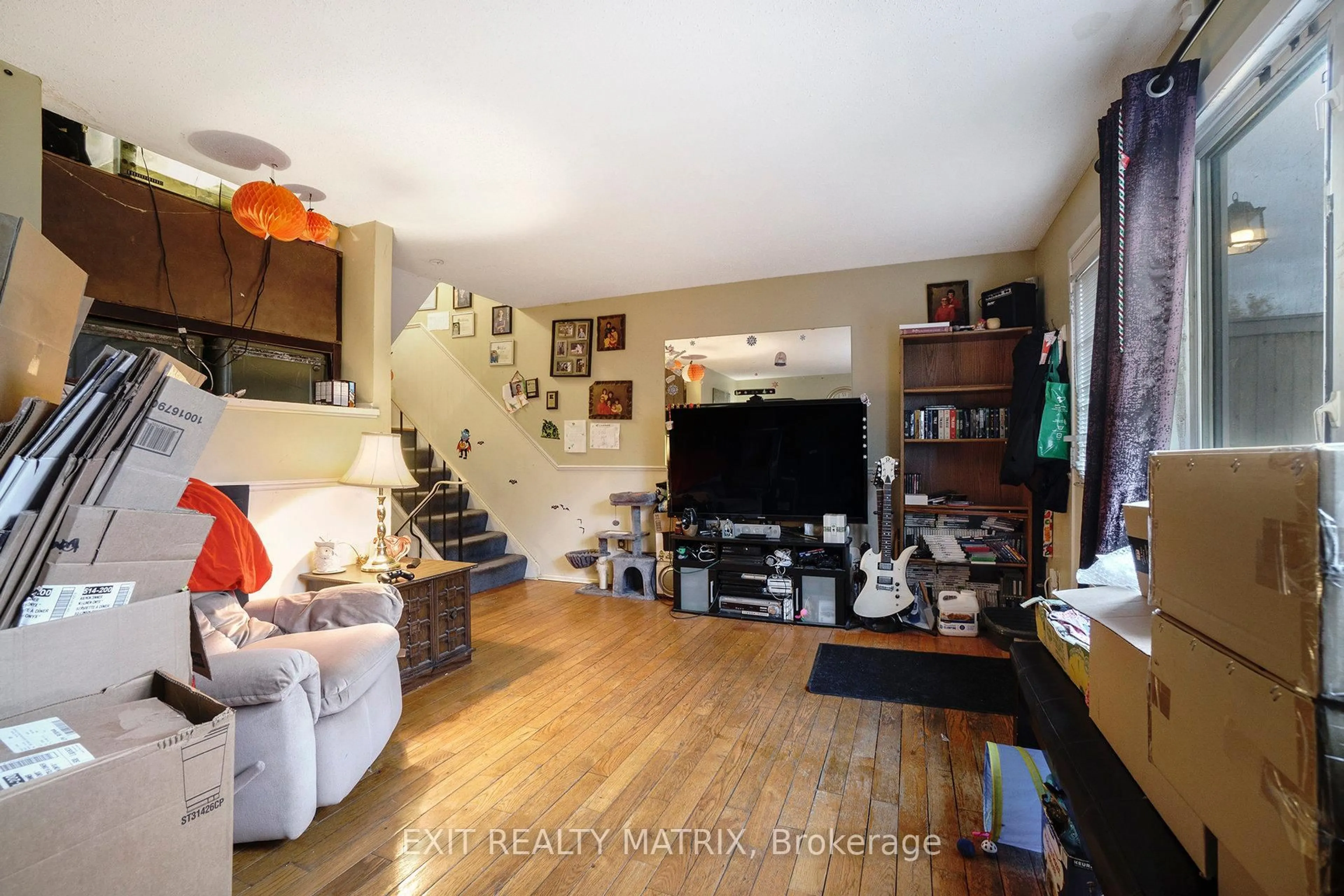 Living room with furniture, wood/laminate floor for 48 Peary Way, Ottawa Ontario K2L 1Z8
