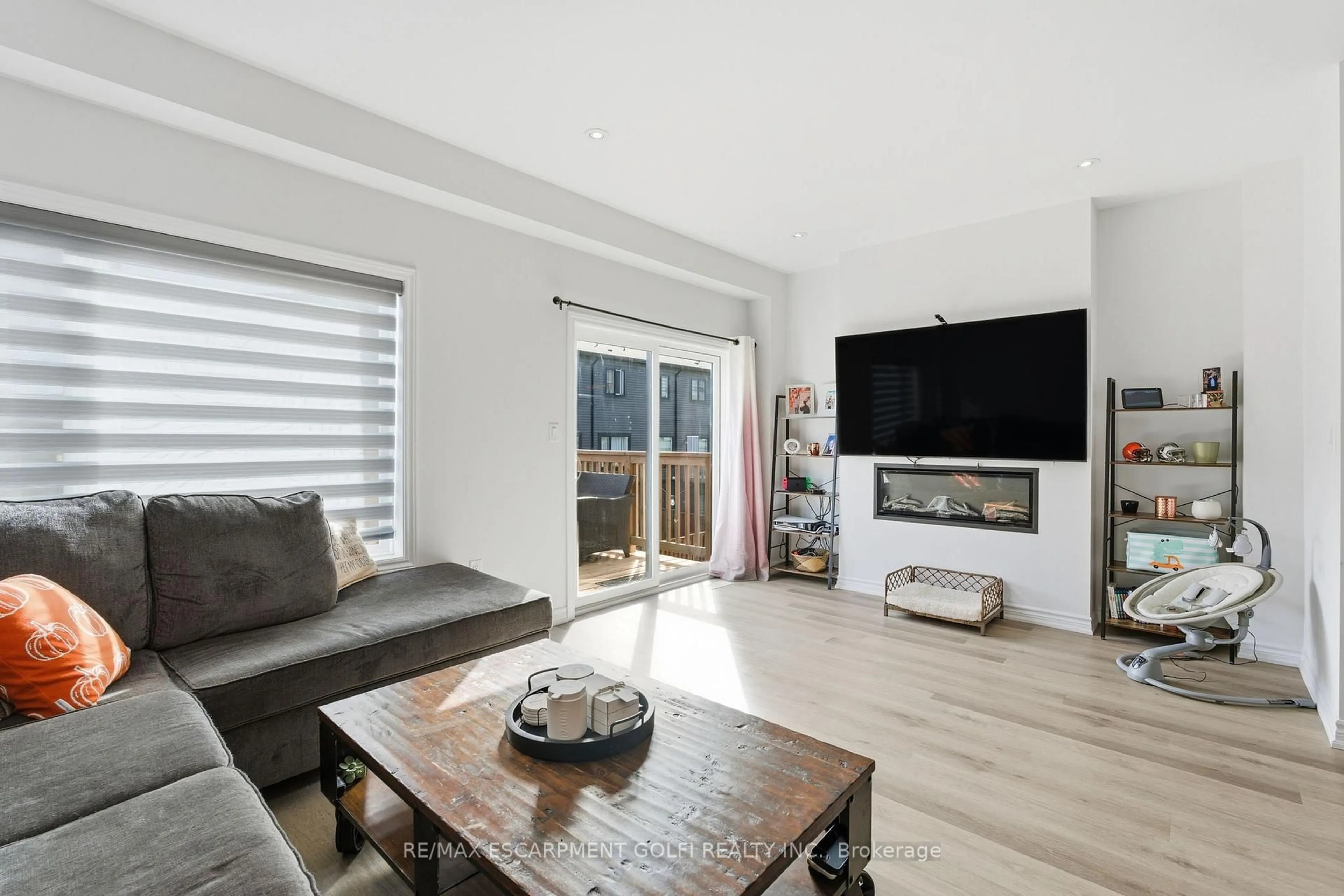 Living room with furniture, wood/laminate floor for 48 Capstone Lane, Hamilton Ontario L9C 0E8