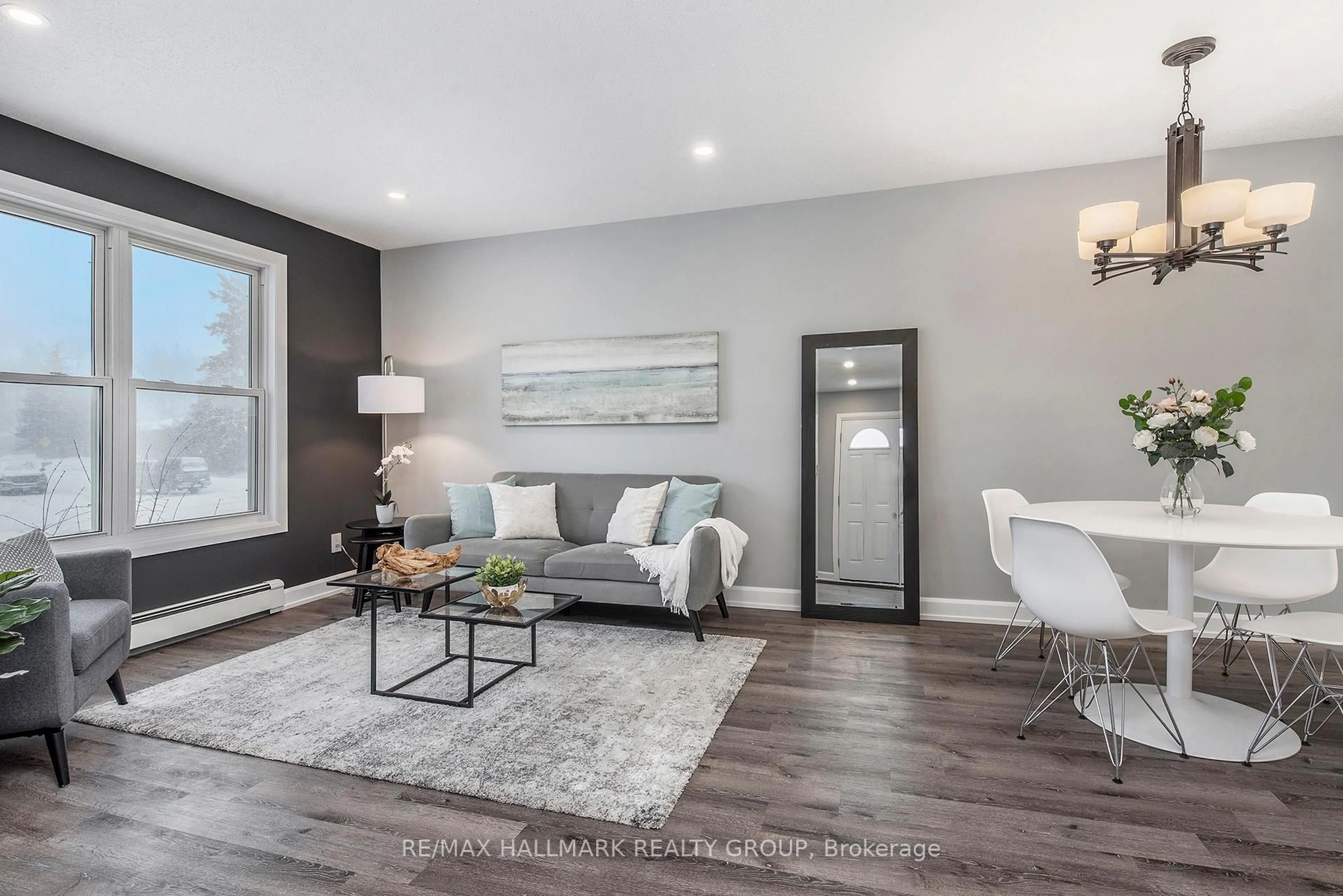 Living room with furniture, wood/laminate floor for 242 Castlefrank Rd, Kanata Ontario K2L 1T5
