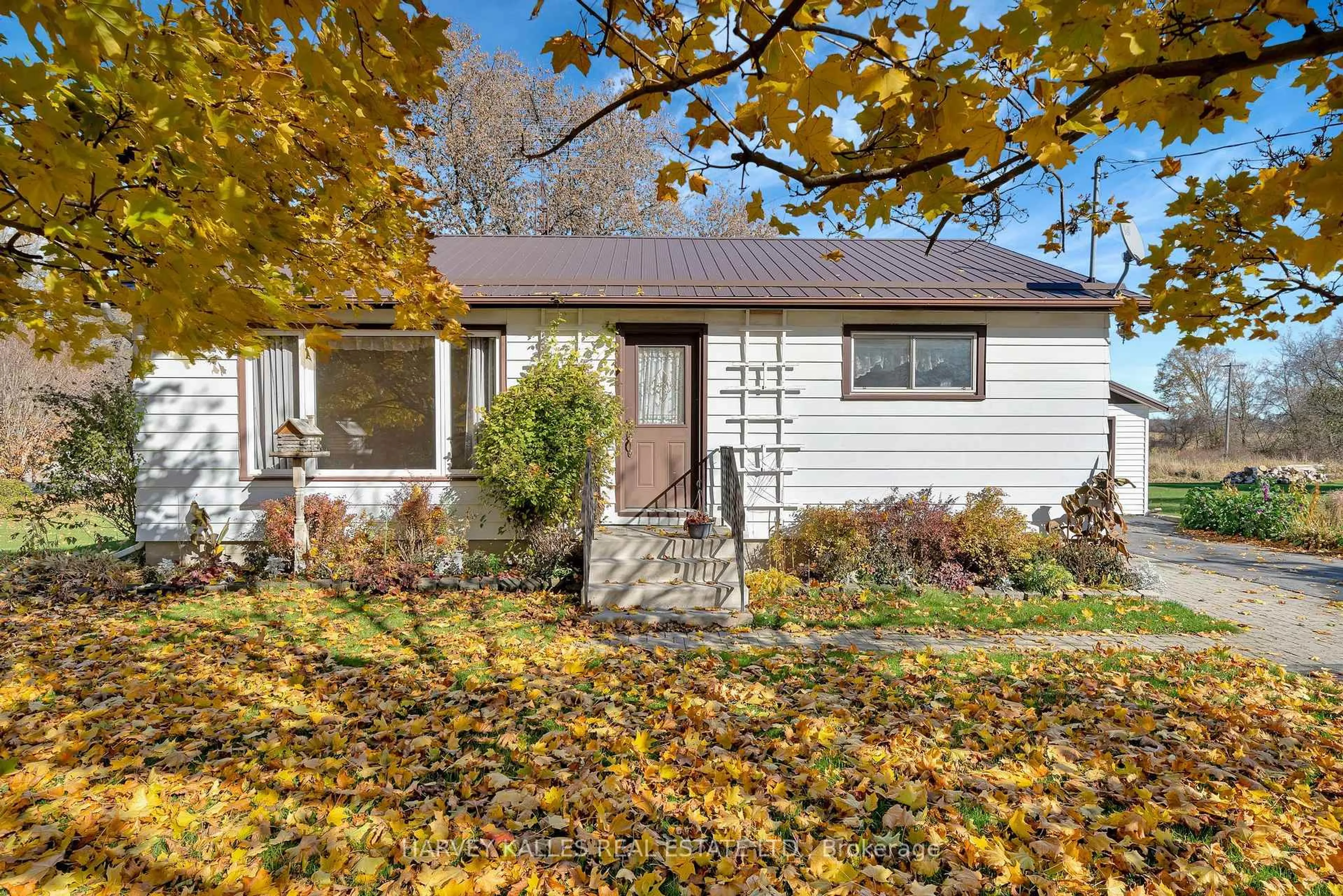 Home with vinyl exterior material, street for 1075 County Rd 10 Rd, Prince Edward County Ontario K0K 2T0