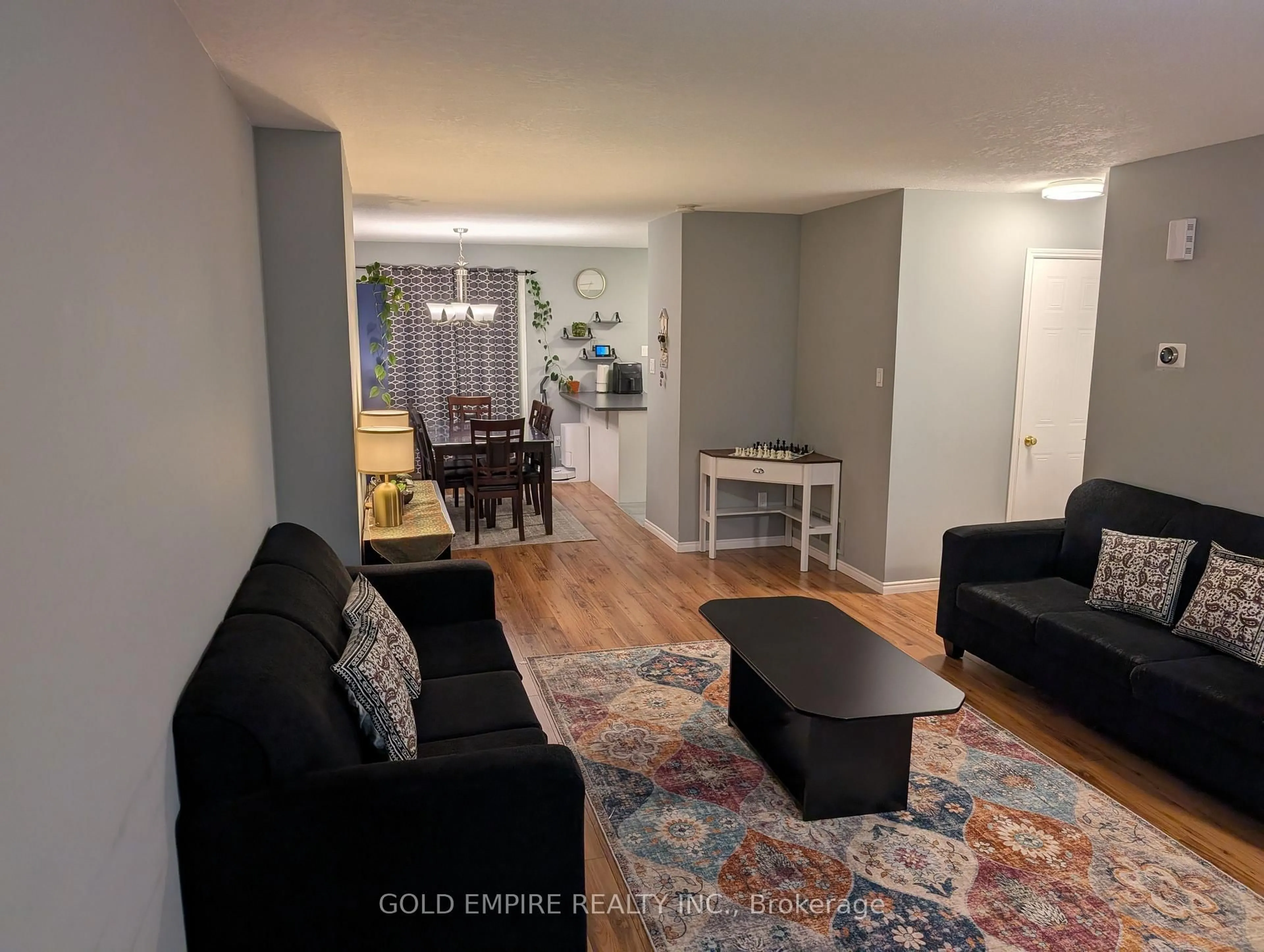 Living room with furniture, wood/laminate floor for 925 LAWSON Rd #40, London North Ontario N6G 4X3