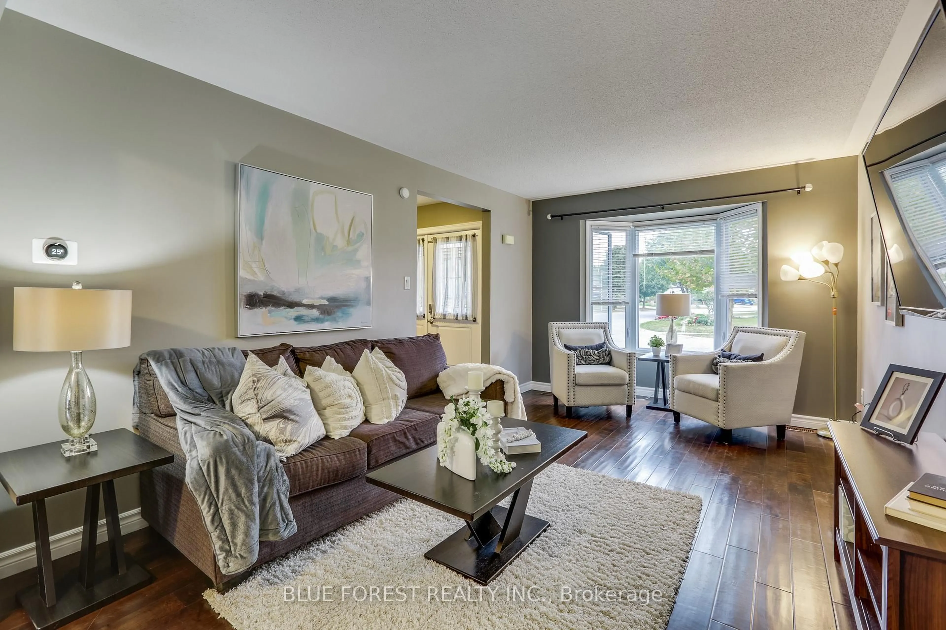 Living room with furniture, wood/laminate floor for 27 Loggers Grve, London East Ontario N5W 5Y9