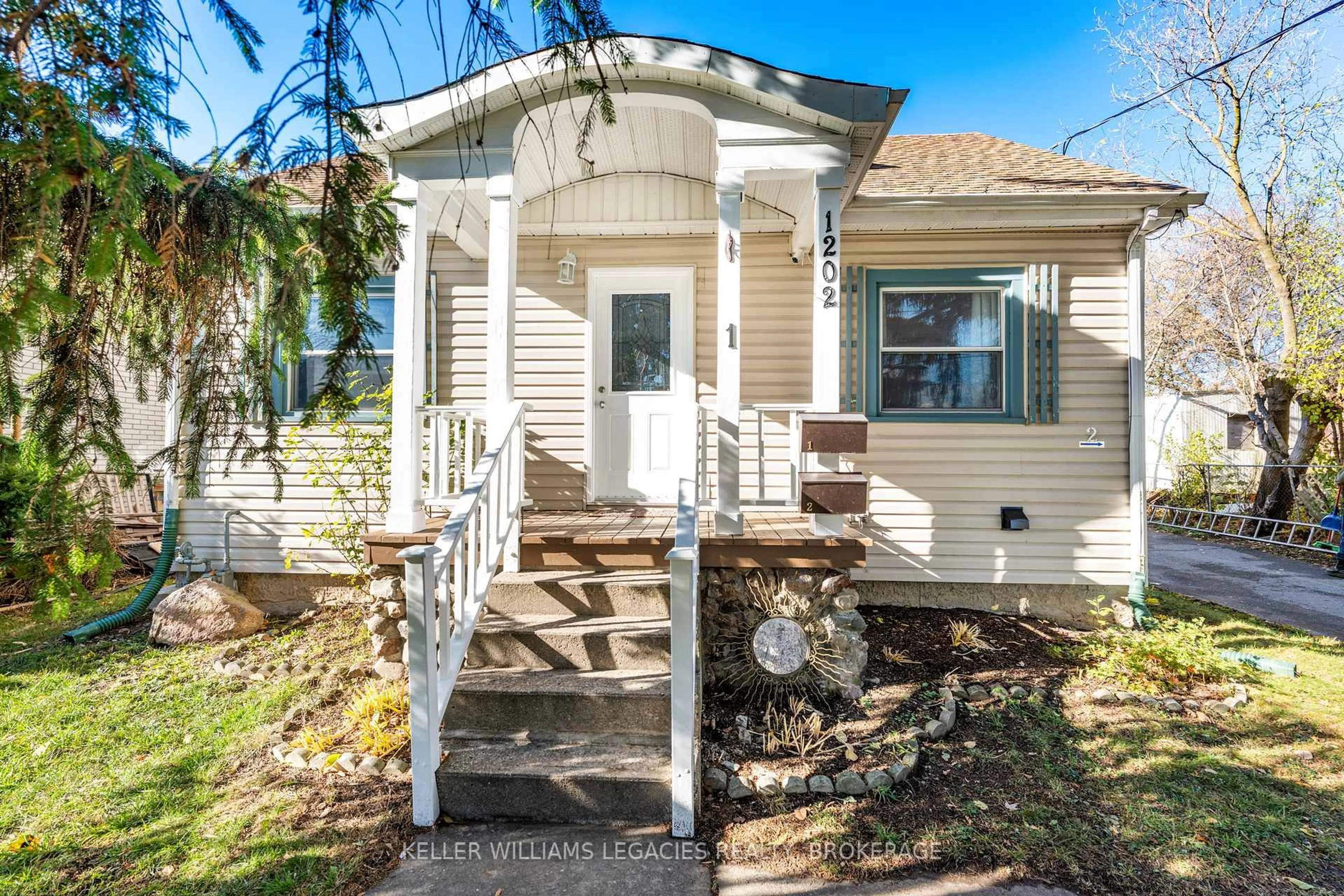 Home with vinyl exterior material, street for 1202 MONTREAL St, Kingston Ontario K7K 3L1