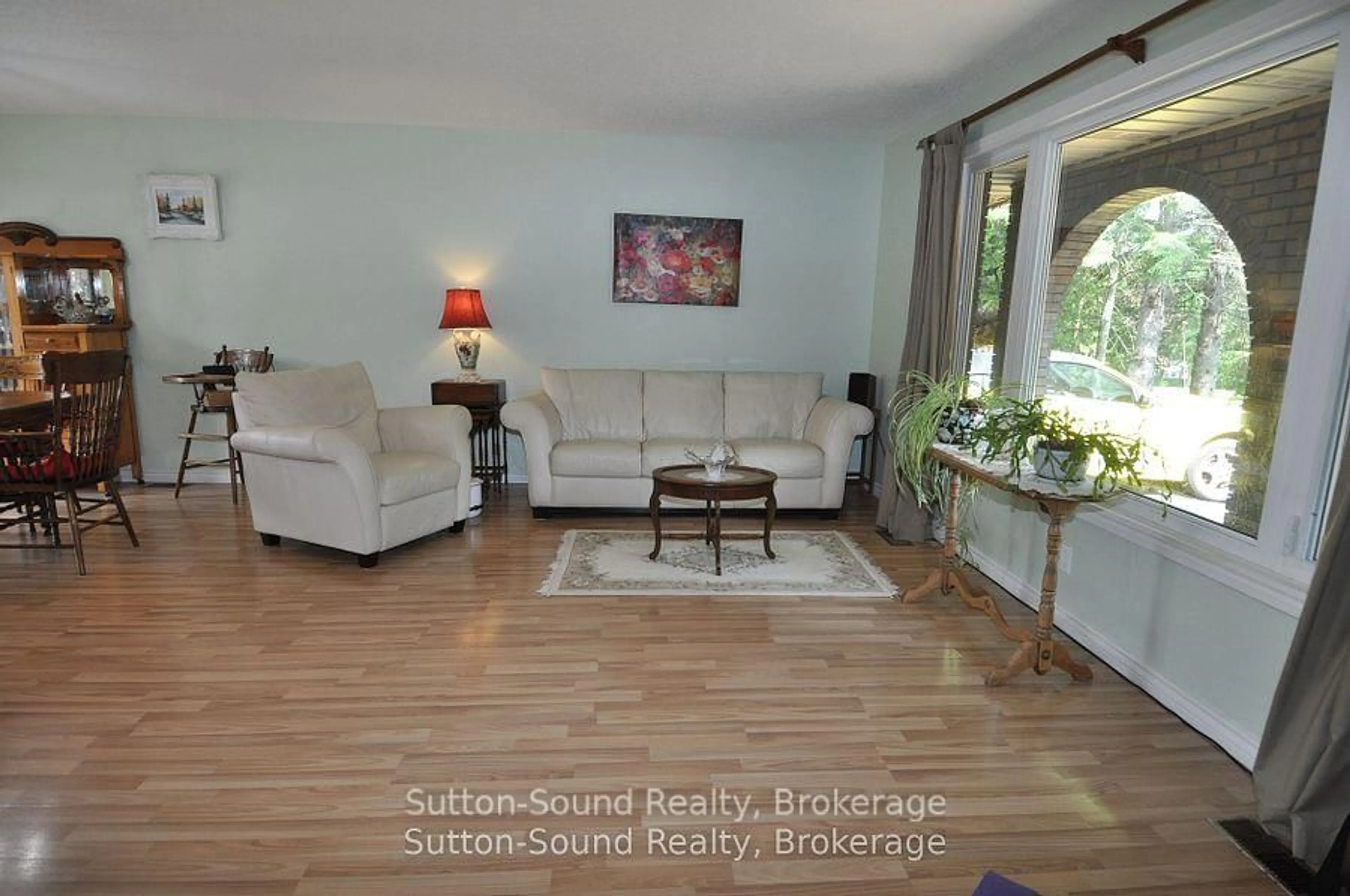 Living room with furniture, wood/laminate floor for 719140 Highway 6 Highway, Georgian Bluffs Ontario N0H 2K0