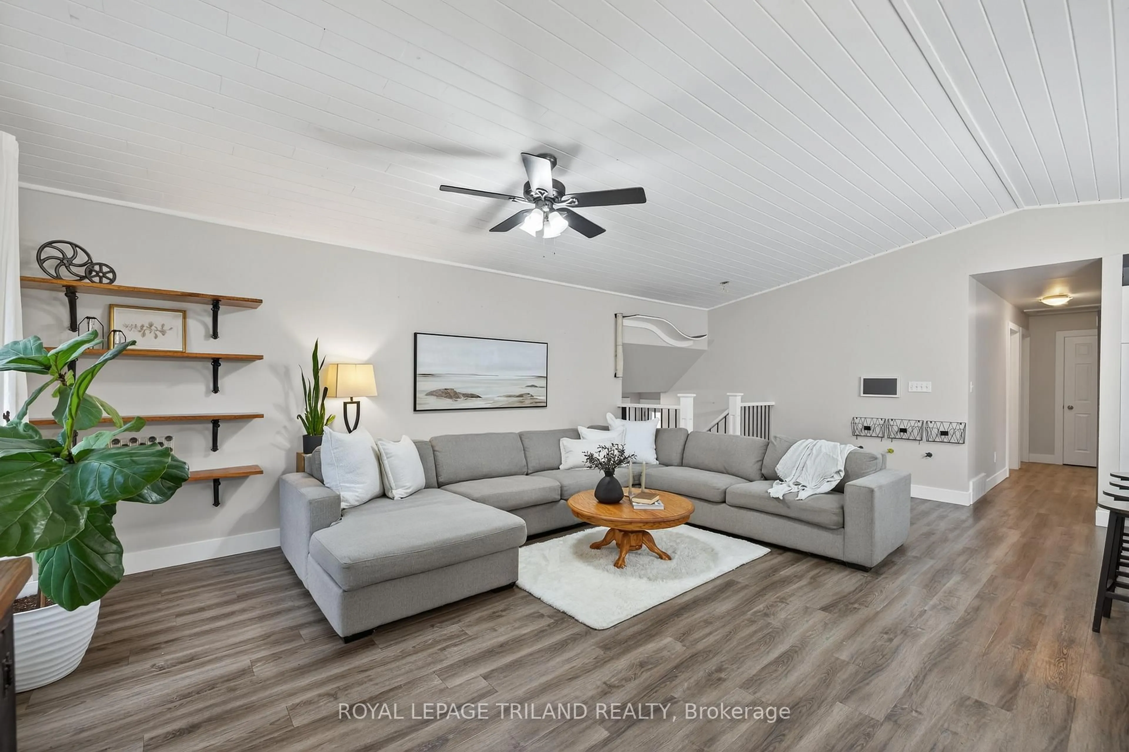 Living room with furniture, wood/laminate floor for 11565 Springfield Rd, Malahide Ontario N5H 2R3