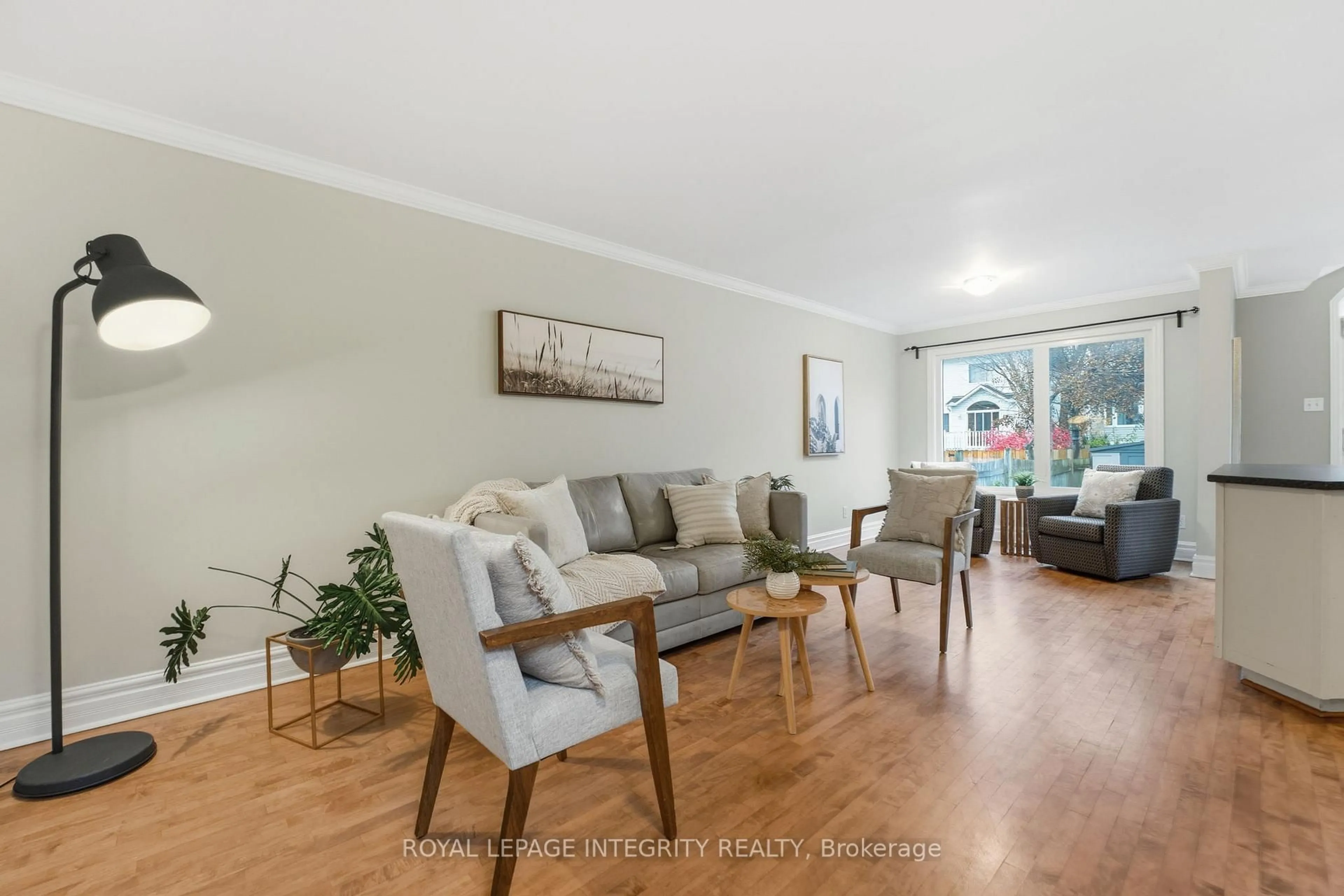 Living room with furniture, wood/laminate floor for 27 Flowertree Cres, Kanata Ontario K2M 2R8