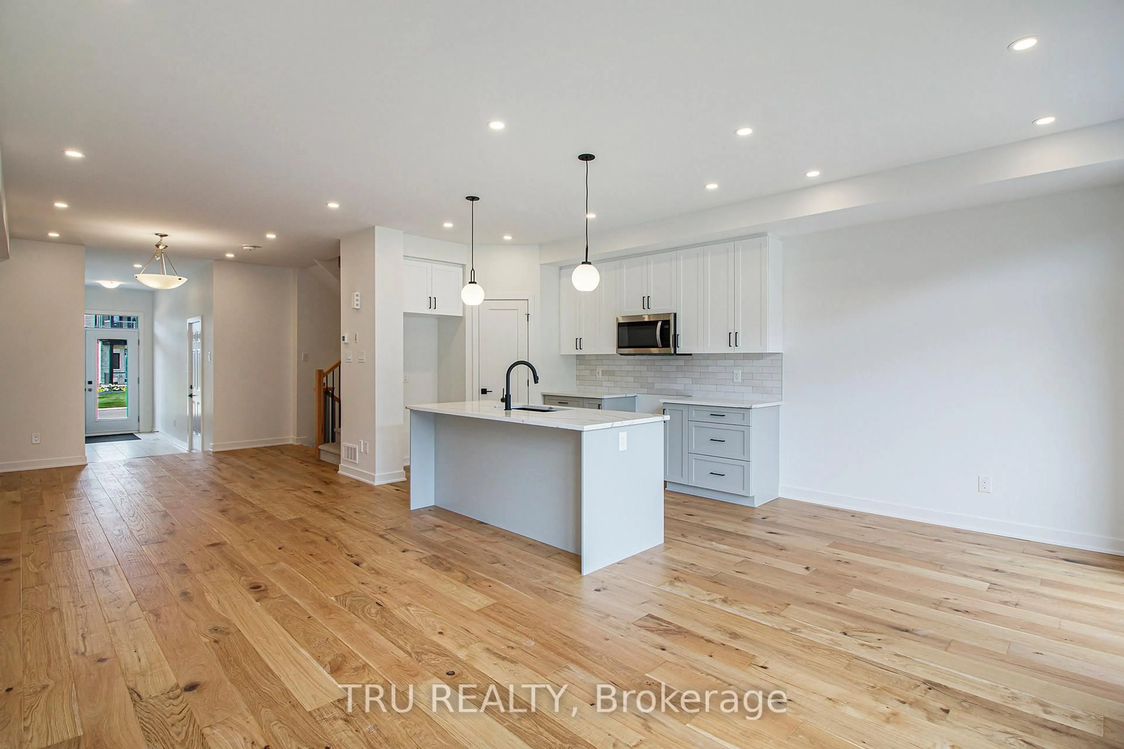 Open concept kitchen, wood/laminate floor for 947 Cologne St, Russell Ontario K0A 1W0