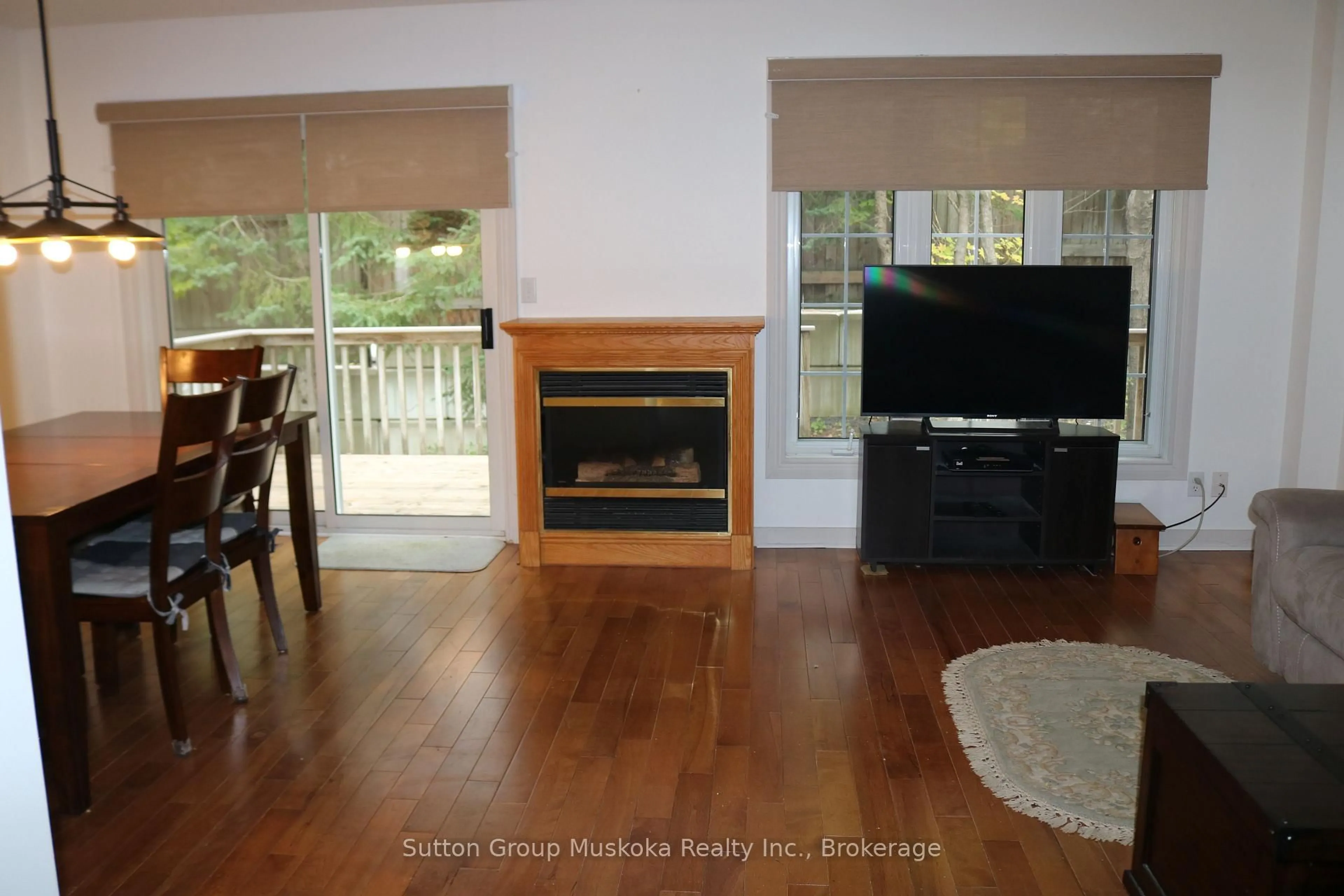 Living room with furniture, wood/laminate floor for 20 Dairy Lane #B1, Huntsville Ontario P1H 2L1