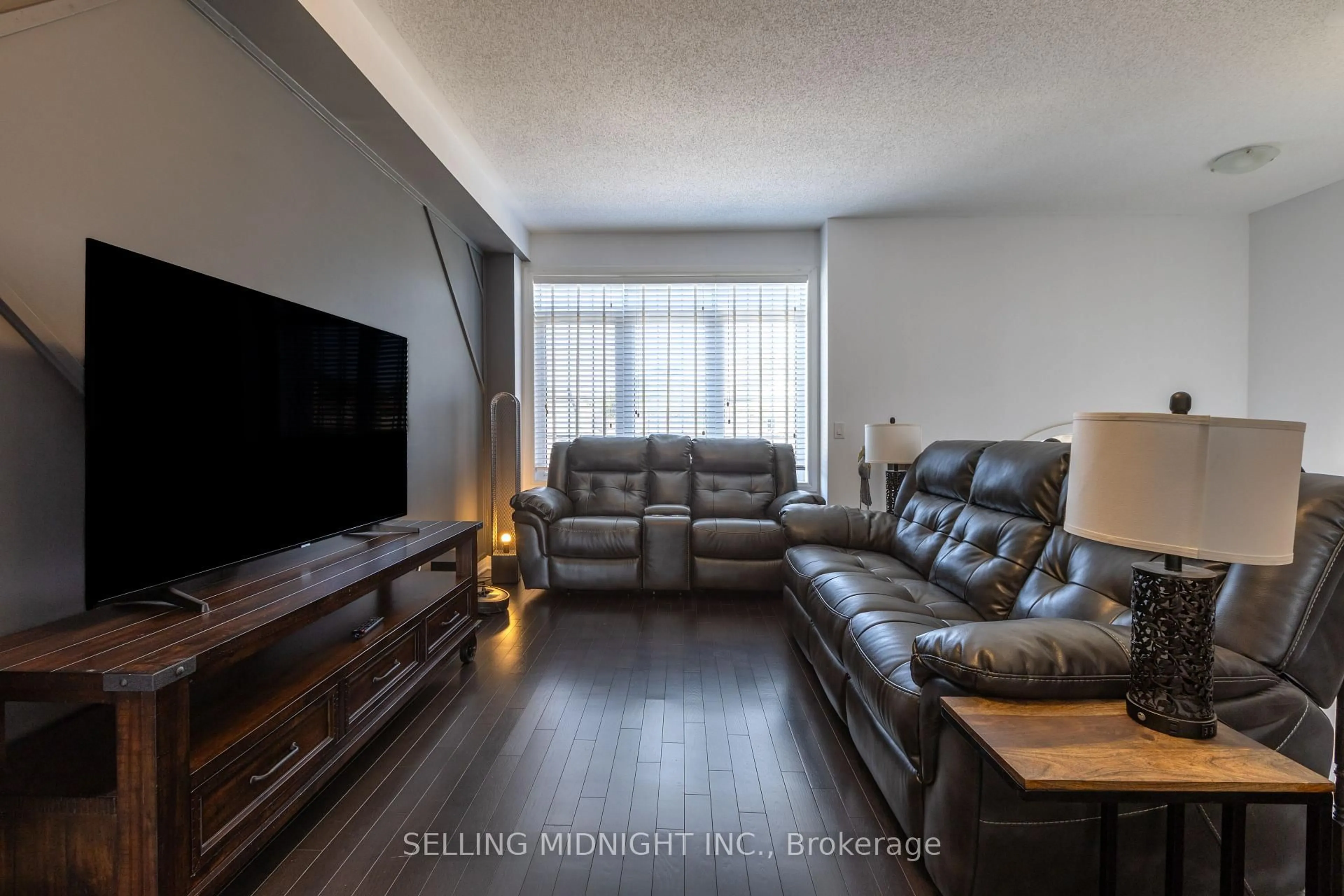 Living room with furniture, wood/laminate floor for 4020 Fracchioni Dr, Lincoln Ontario L3J 0R8