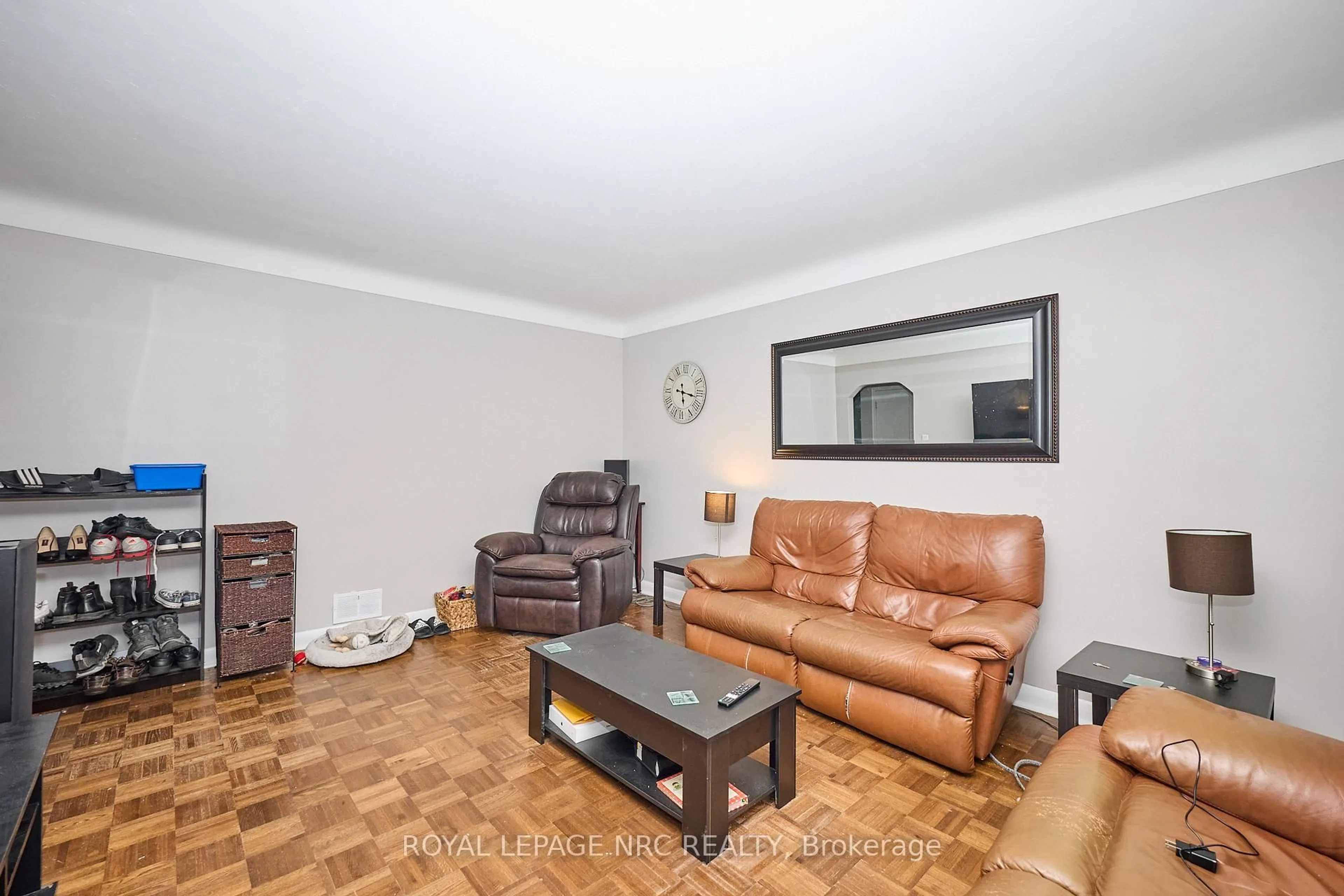 Living room with furniture, wood/laminate floor for 21 Silverdale Dr, St. Catharines Ontario L2M 3M9