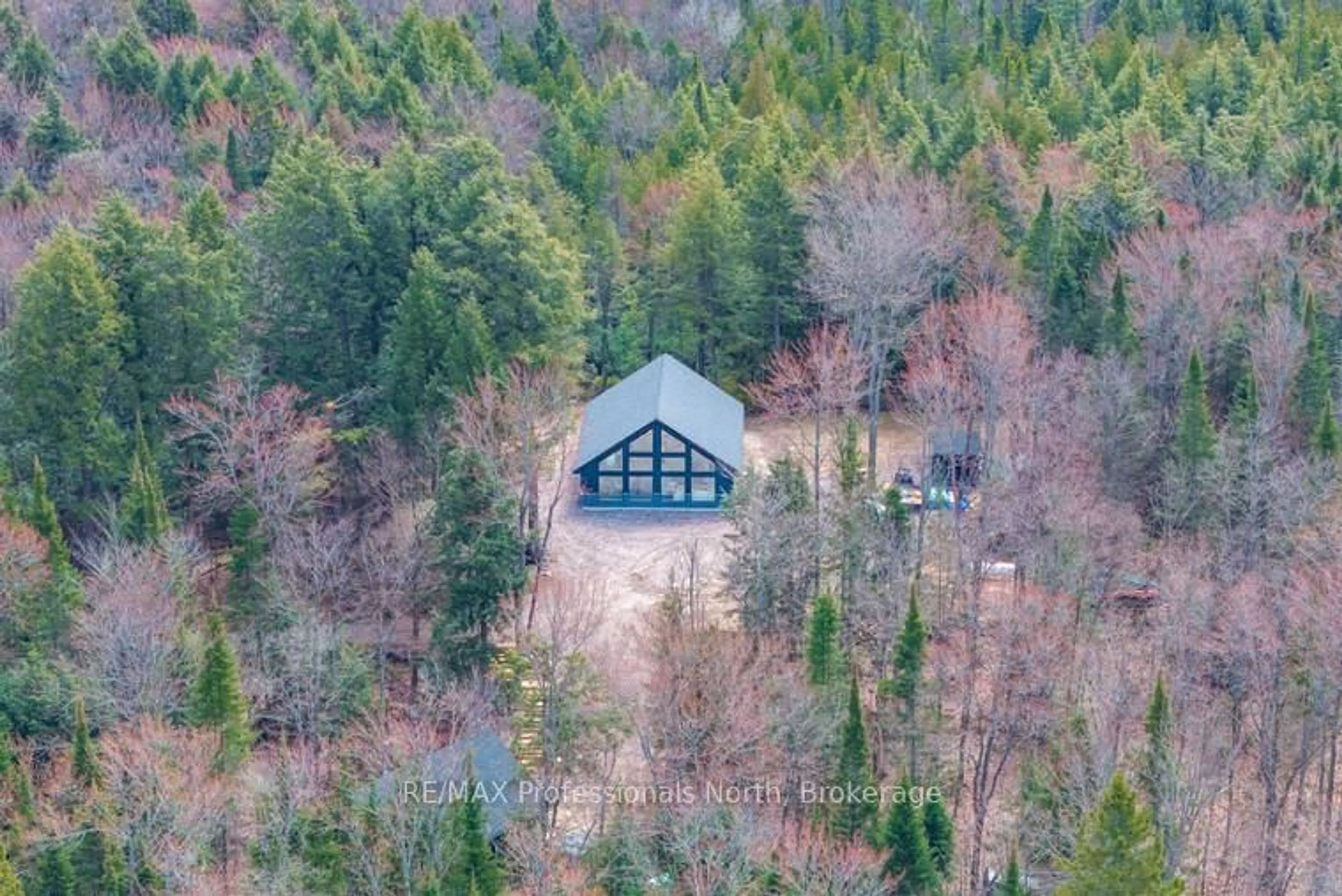 A pic from outside/outdoor area/front of a property/back of a property/a pic from drone, forest/trees view for 1820 Riding Ranch Rd, Machar Ontario P0A 1X0