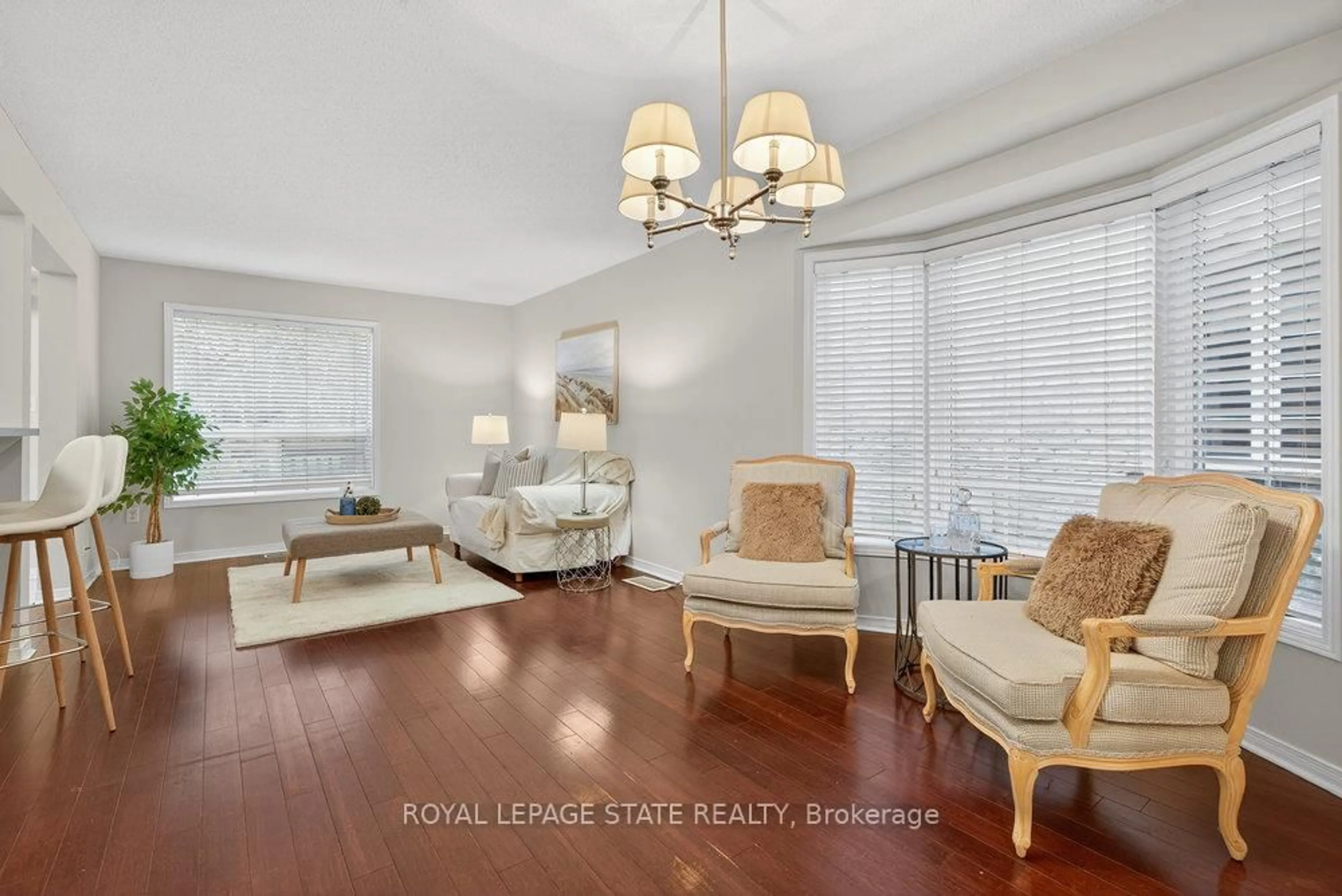 Living room with furniture, wood/laminate floor for 76 Frances Ave #37, Hamilton Ontario L8E 5X2