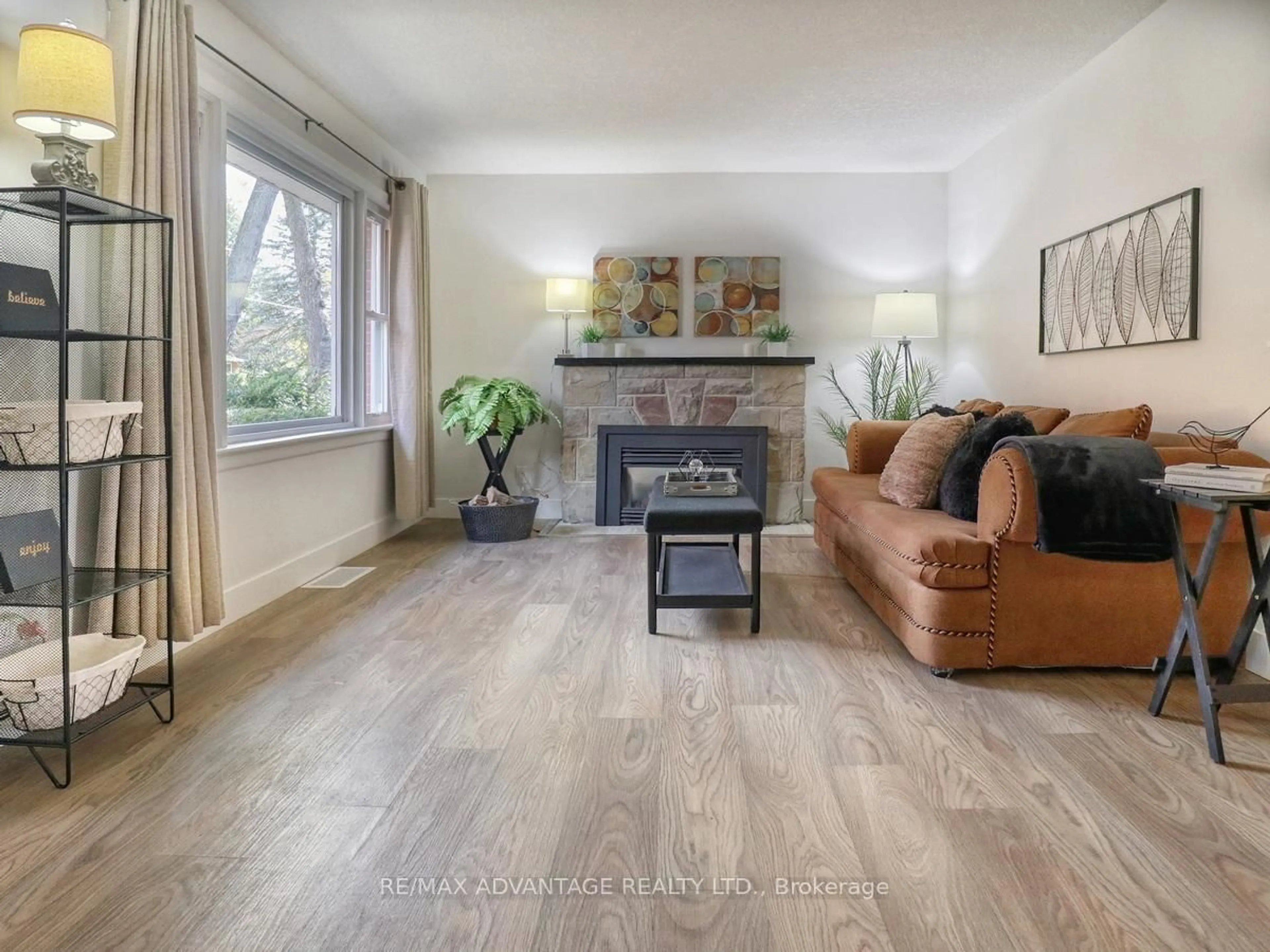 Living room with furniture, wood/laminate floor for 401 Stephen St, London South Ontario N6K 2N4