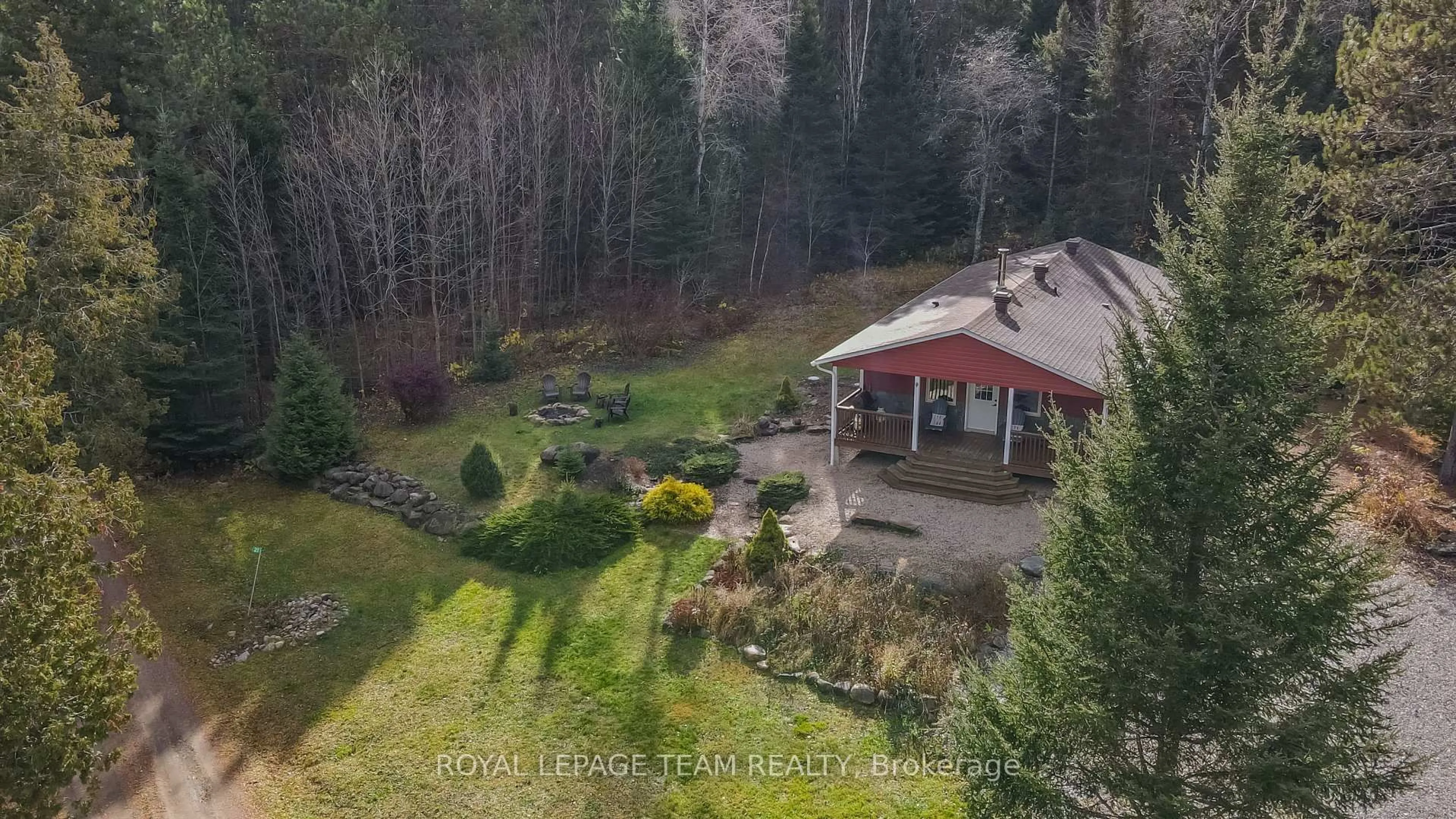 A pic from outside/outdoor area/front of a property/back of a property/a pic from drone, forest/trees view for 21 Dave Bowers Lane, South Algonquin Ontario K0J 2M0