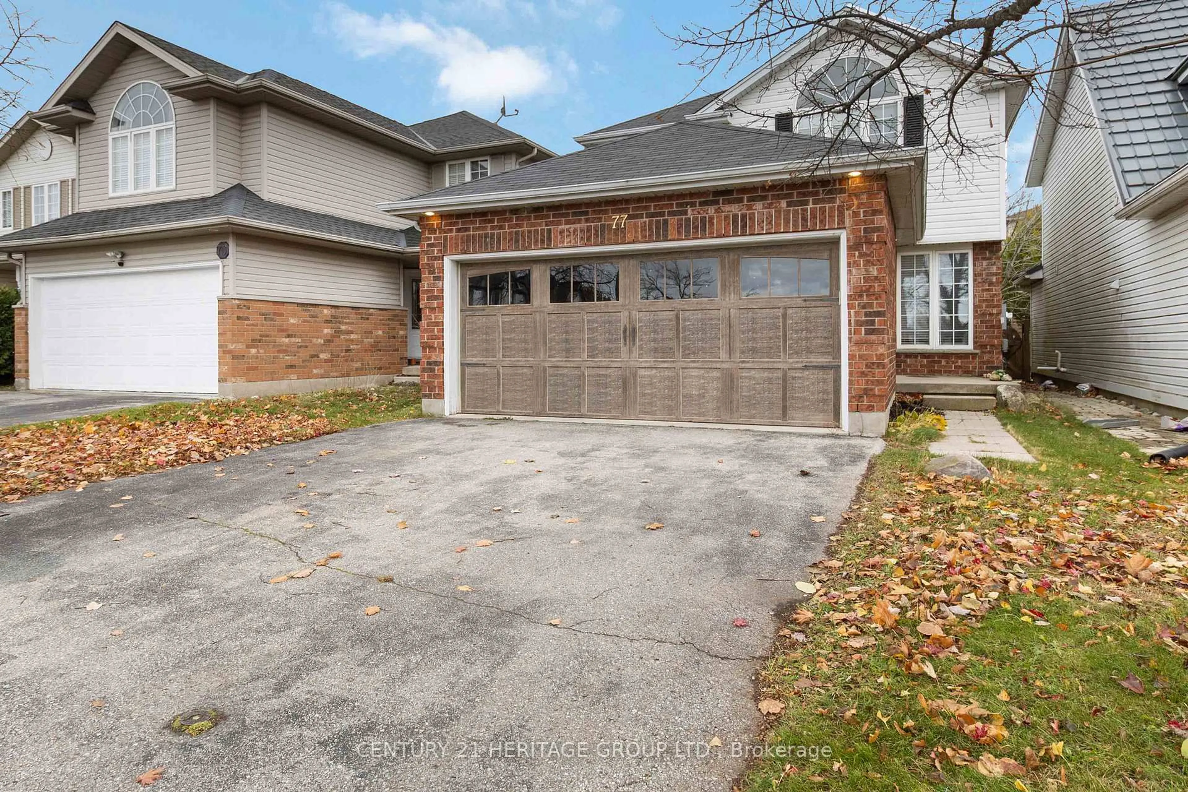 Home with brick exterior material, street for 77 Doyle Dr, Guelph Ontario N1G 5B9