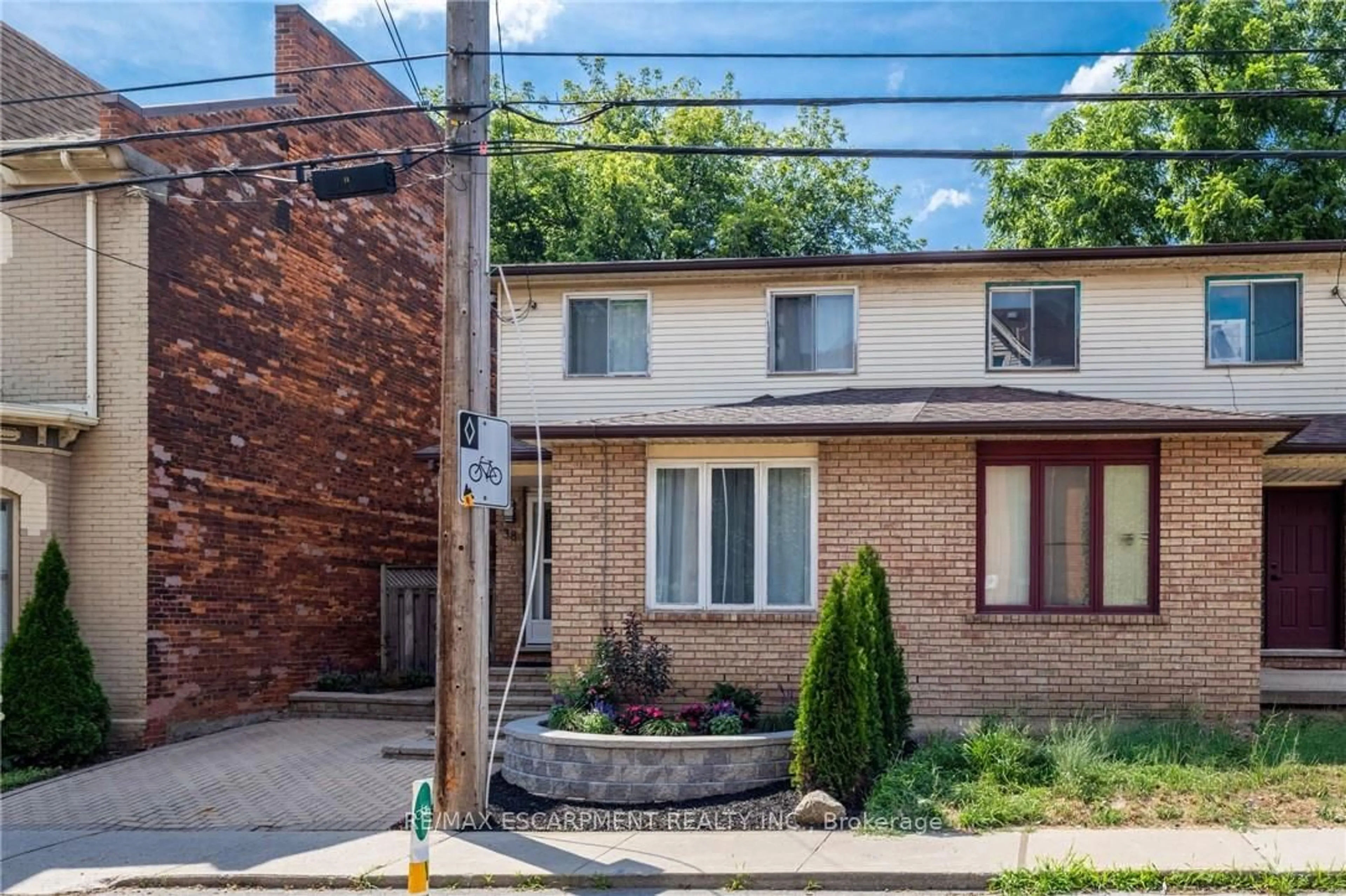 Home with brick exterior material, street for 38 Locke St, Hamilton Ontario L8P 3Z8