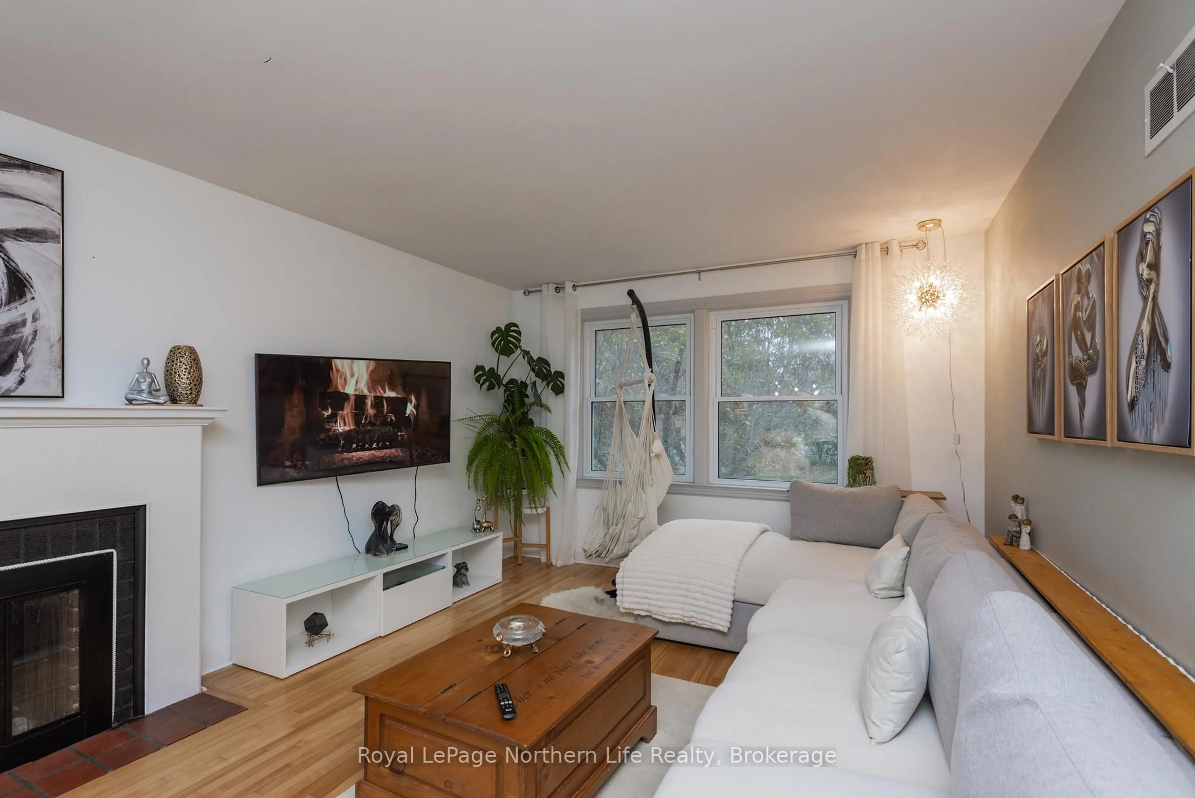 Living room with furniture, wood/laminate floor for 680 Main St, North Bay Ontario P1B 2V5