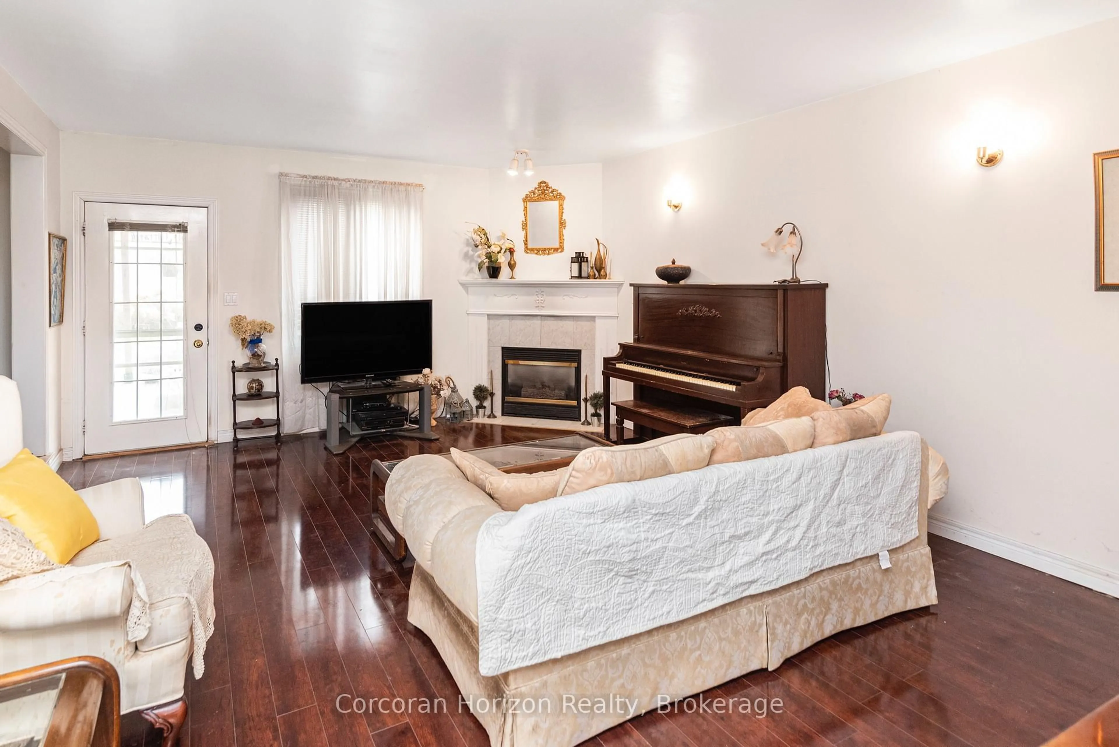 Living room with furniture, wood/laminate floor for 308 Acadia Dr, Hamilton Ontario L8W 3L1