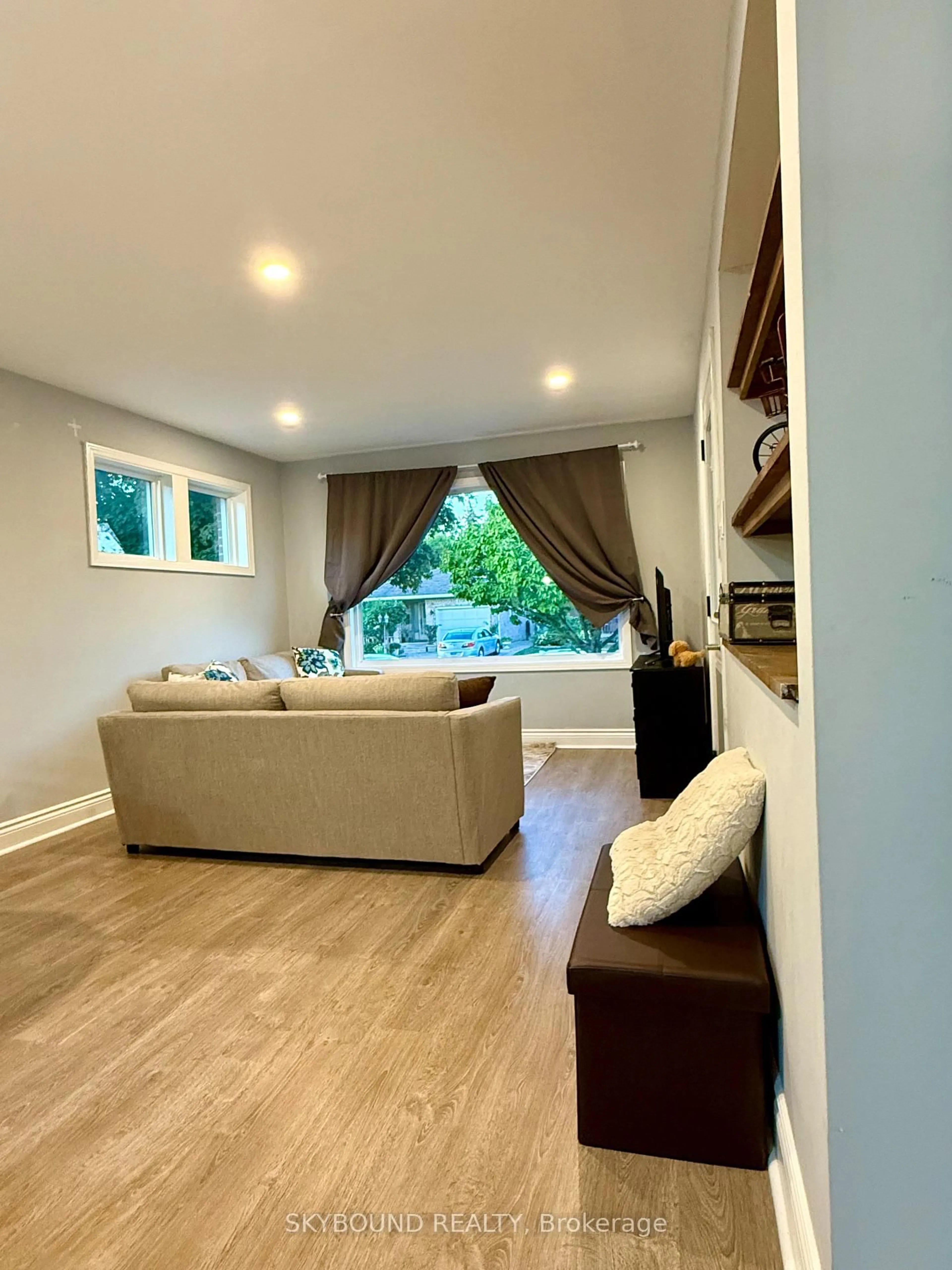 Living room with furniture, wood/laminate floor for 1723 Langlois Ave, Windsor Ontario N8X 4M4