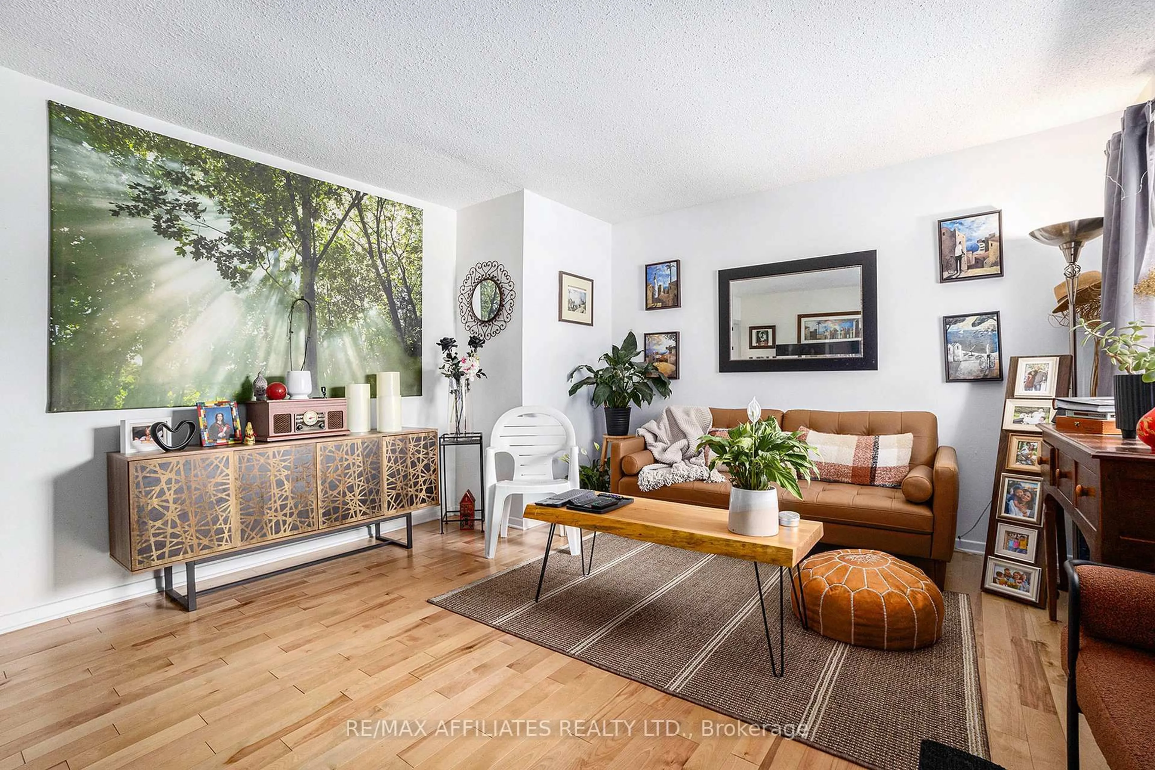 Living room with furniture, wood/laminate floor for 6208 Renaud Rd, Orleans Ontario K1W 0L1