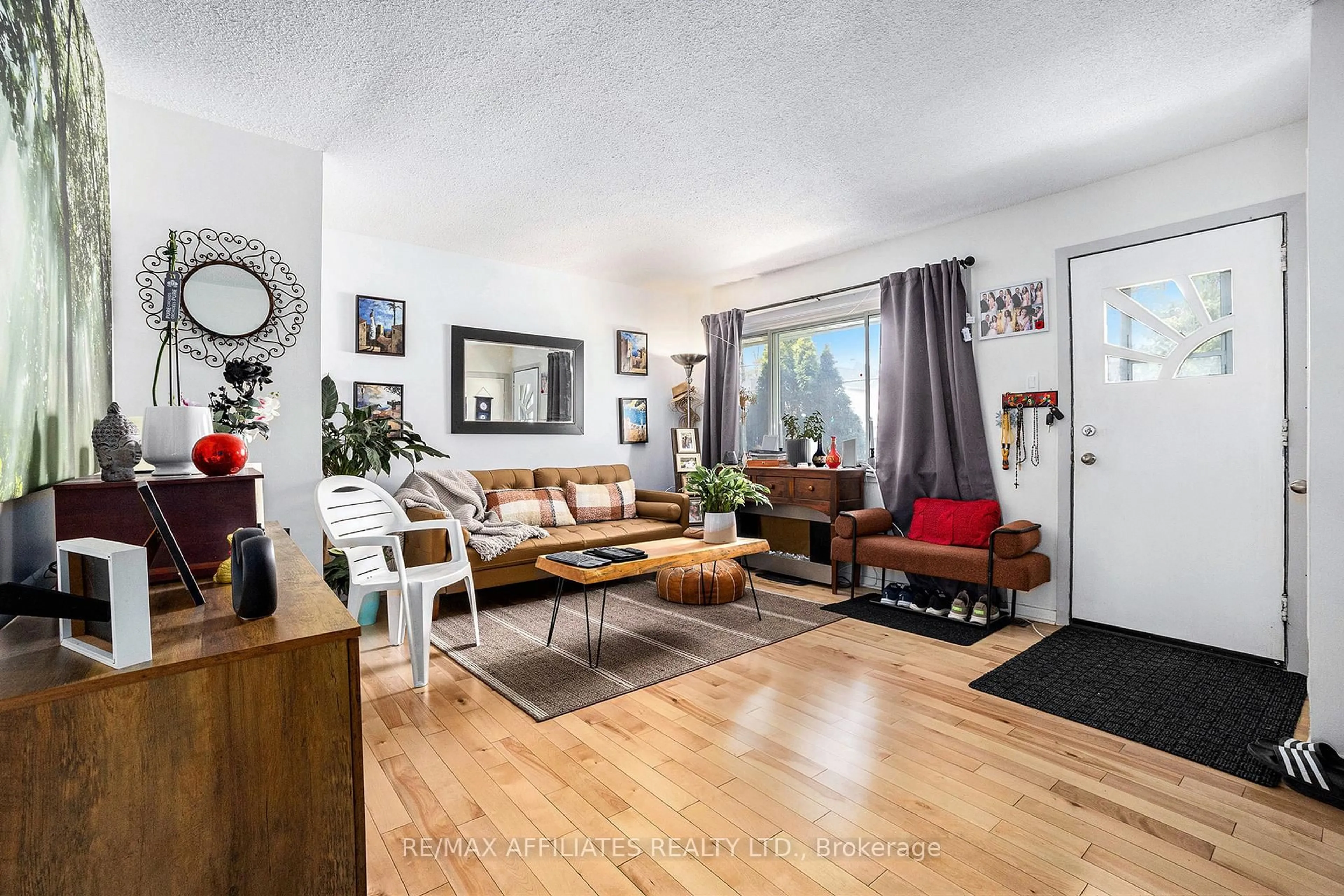 Living room with furniture, wood/laminate floor for 6208 Renaud Rd, Orleans Ontario K1W 0L1