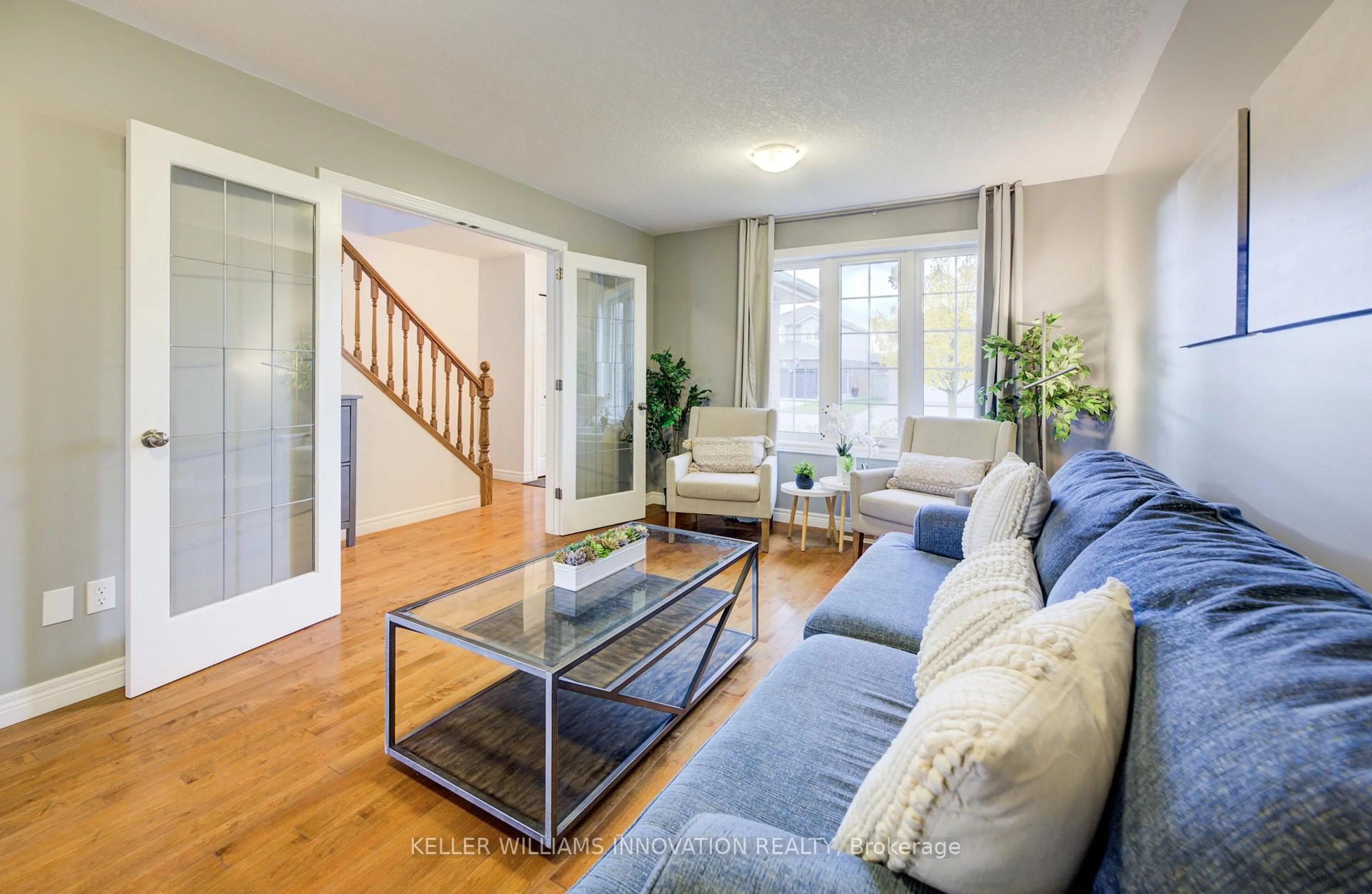 Living room with furniture, wood/laminate floor for 213 Falcon Dr, Woodstock Ontario N4T 1W5