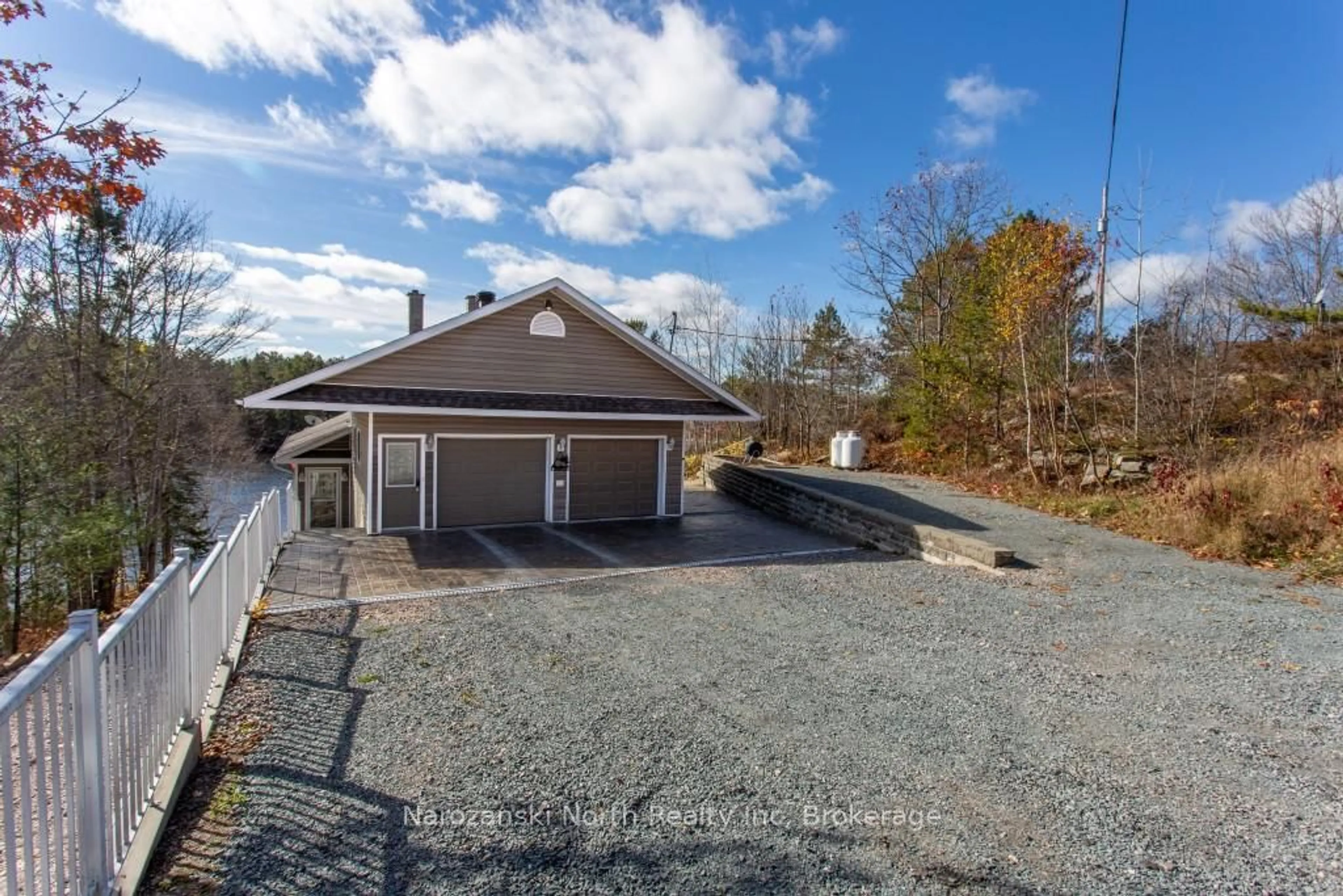 A pic from outside/outdoor area/front of a property/back of a property/a pic from drone, water/lake/river/ocean view for 56 Island Rd, St. Charles Ontario P0M 2W0