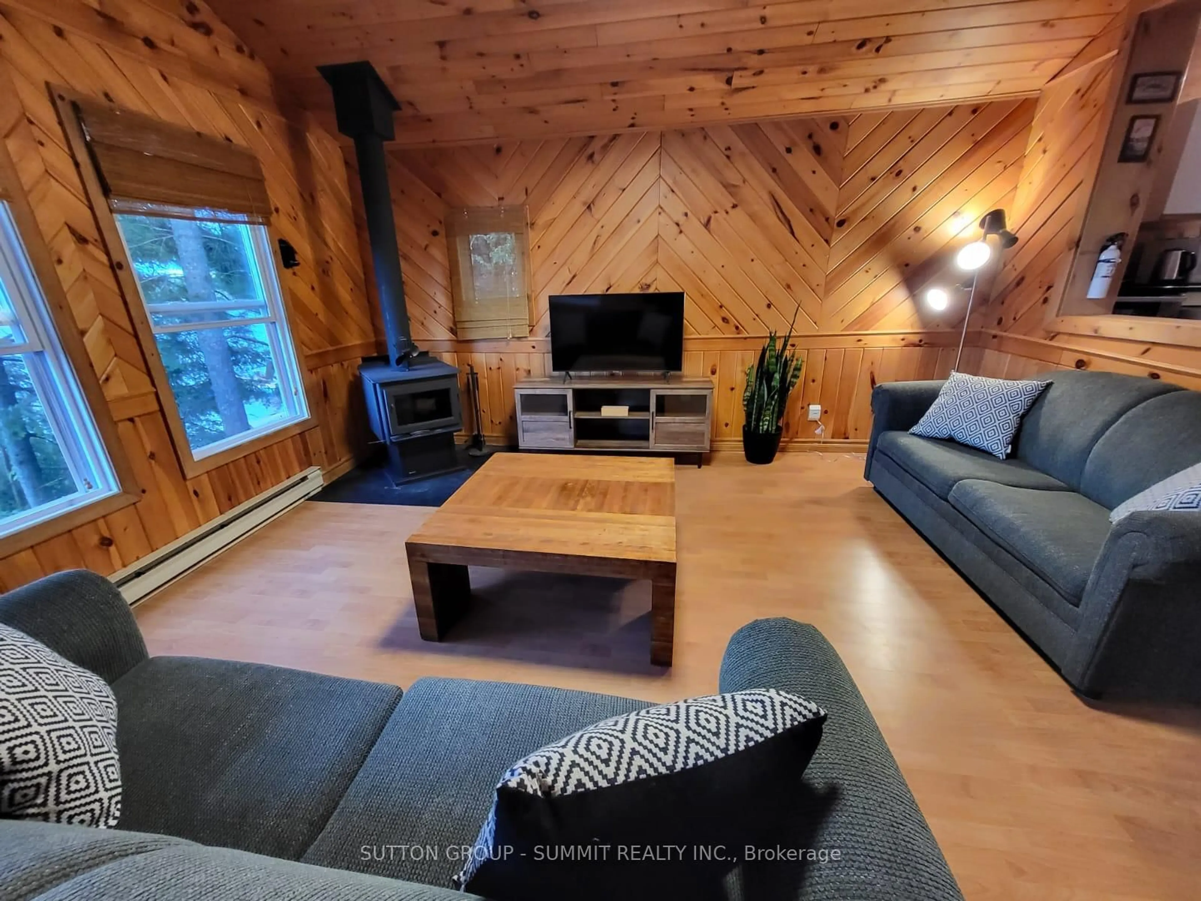 Living room with furniture, wood/laminate floor for 98 West Ham Lake Rd, Killarney Ontario P0M 1A0