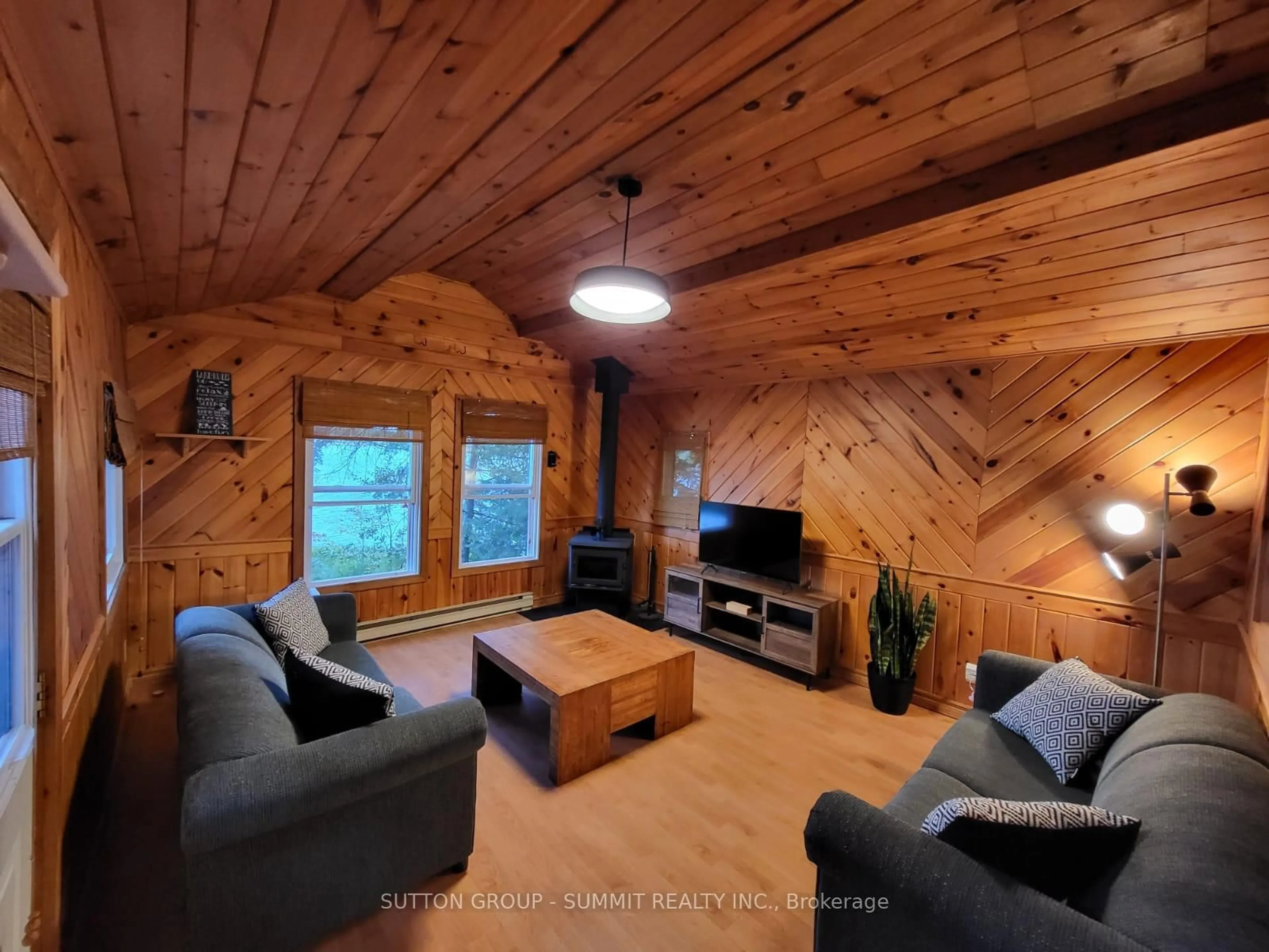 Living room with furniture, wood/laminate floor for 98 West Ham Lake Rd, Killarney Ontario P0M 1A0