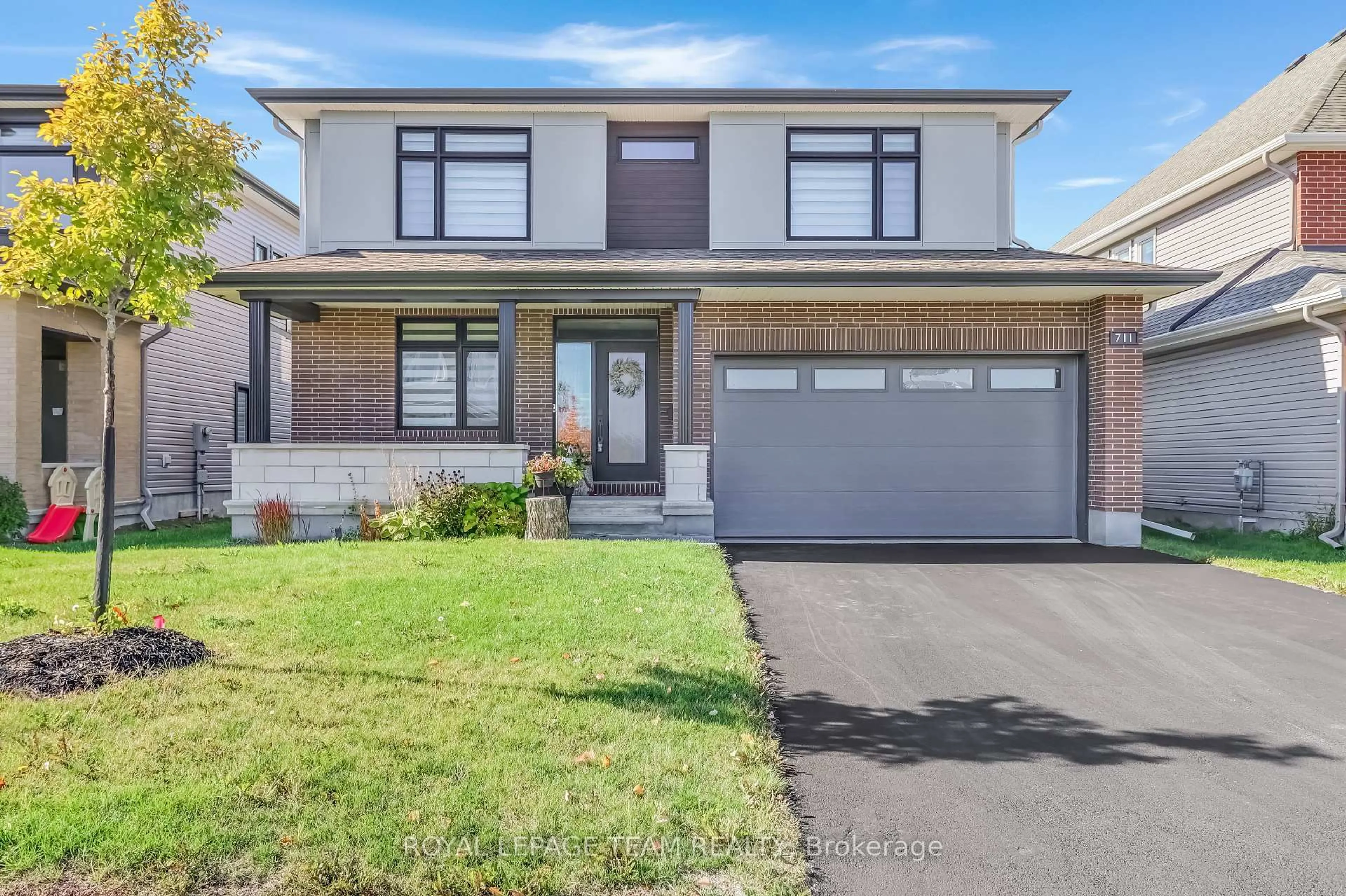 Home with brick exterior material, street for 711 Moonflower Cres, Ottawa Ontario K1T 0X8