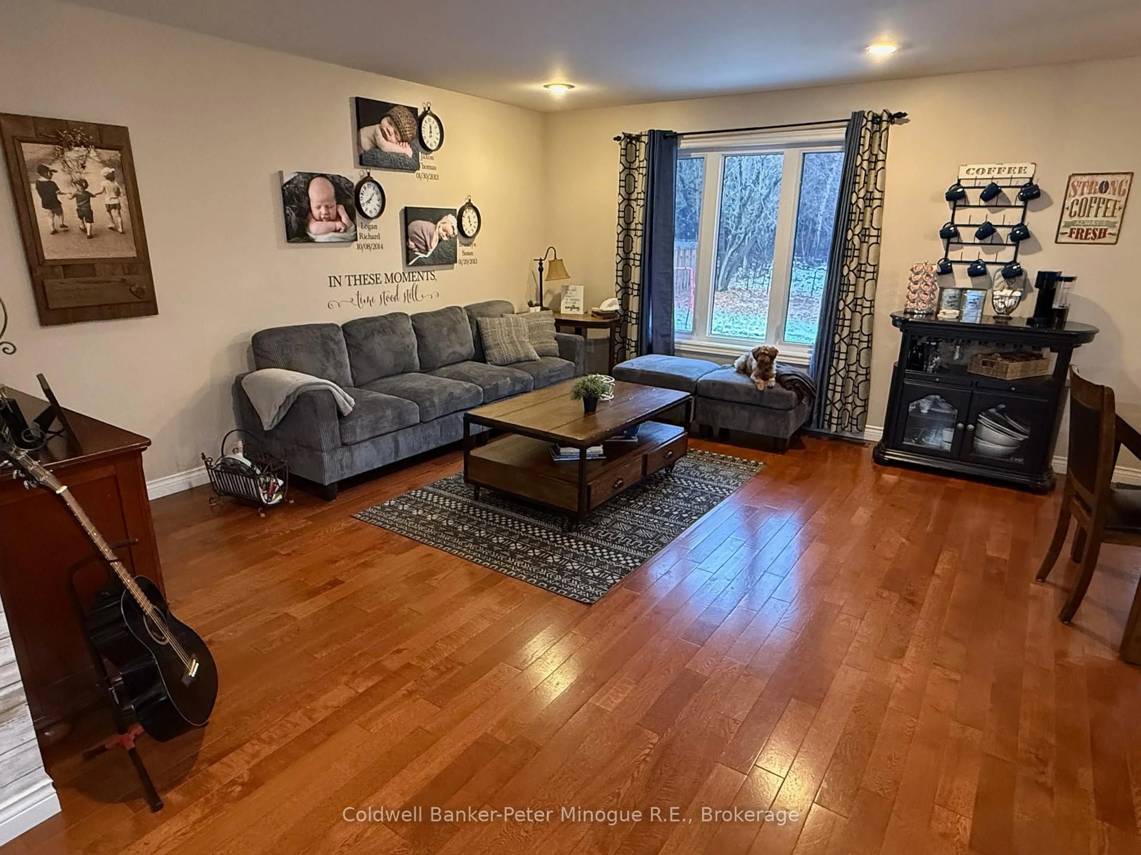 Living room with furniture, wood/laminate floor for 296 Osprey Cres, Callander Ontario P0H 1H0