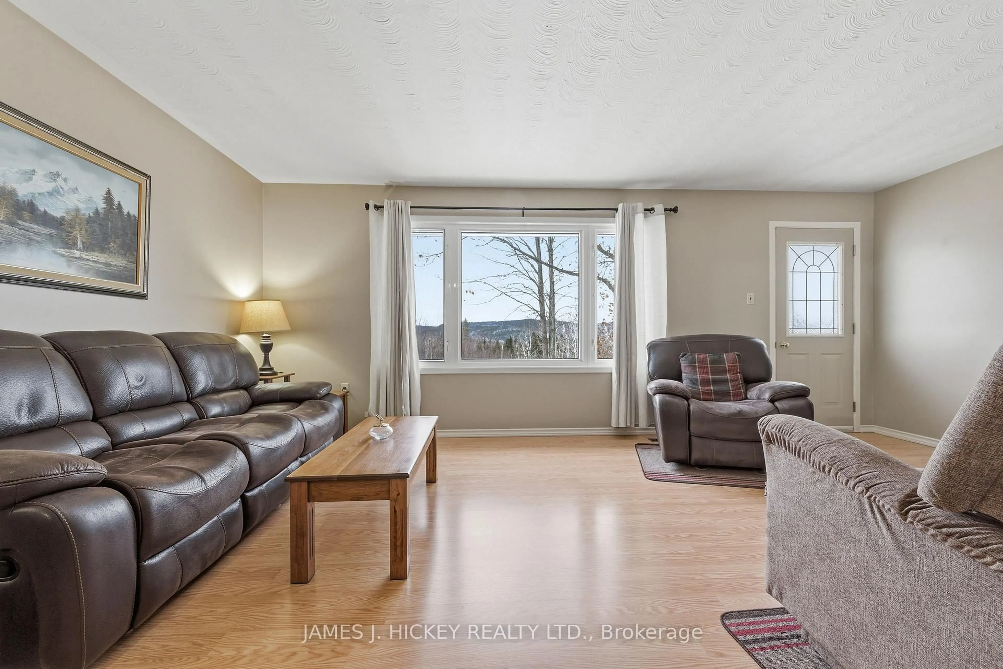 Living room with furniture, wood/laminate floor for 101 Lance Rd, Deep River Ontario K0J 1P0