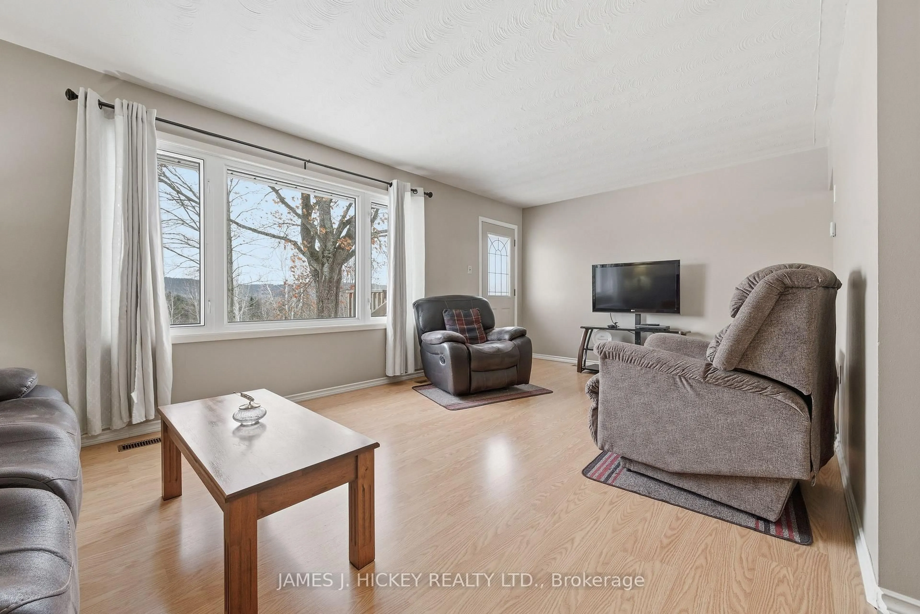 Living room with furniture, wood/laminate floor for 101 Lance Rd, Deep River Ontario K0J 1P0