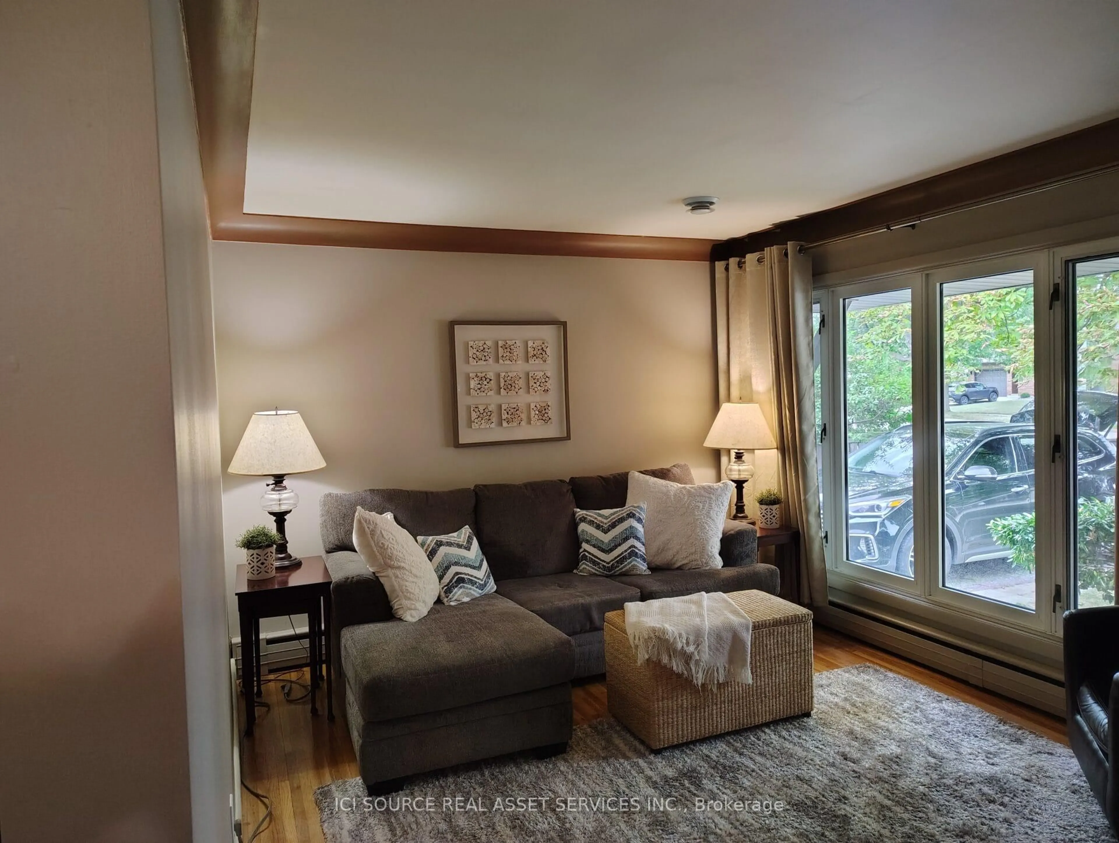 Living room with furniture, wood/laminate floor for 8581 Jerome St, Windsor Ontario N8S 1W8