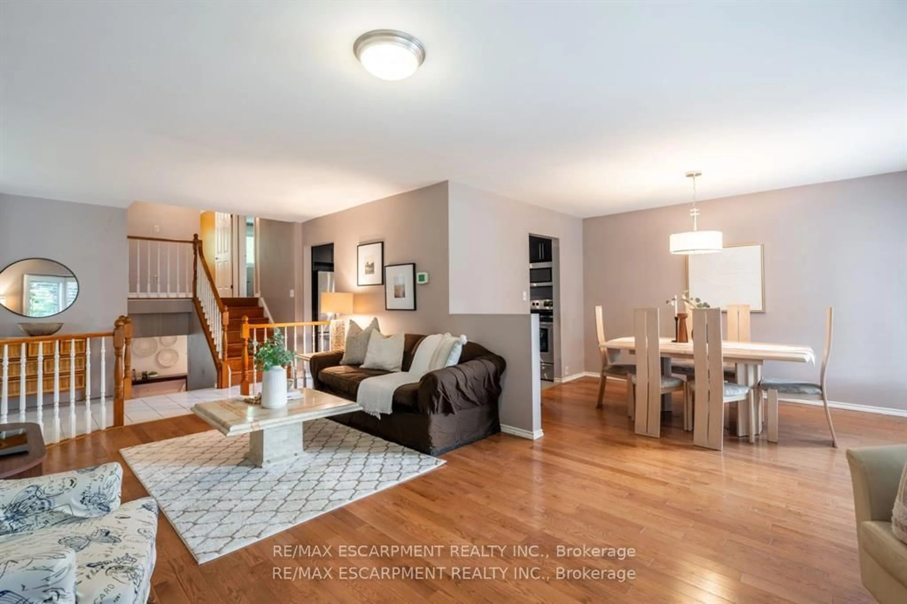 Living room with furniture, wood/laminate floor for 16 Flamingo Dr, Hamilton Ontario L9A 4X7