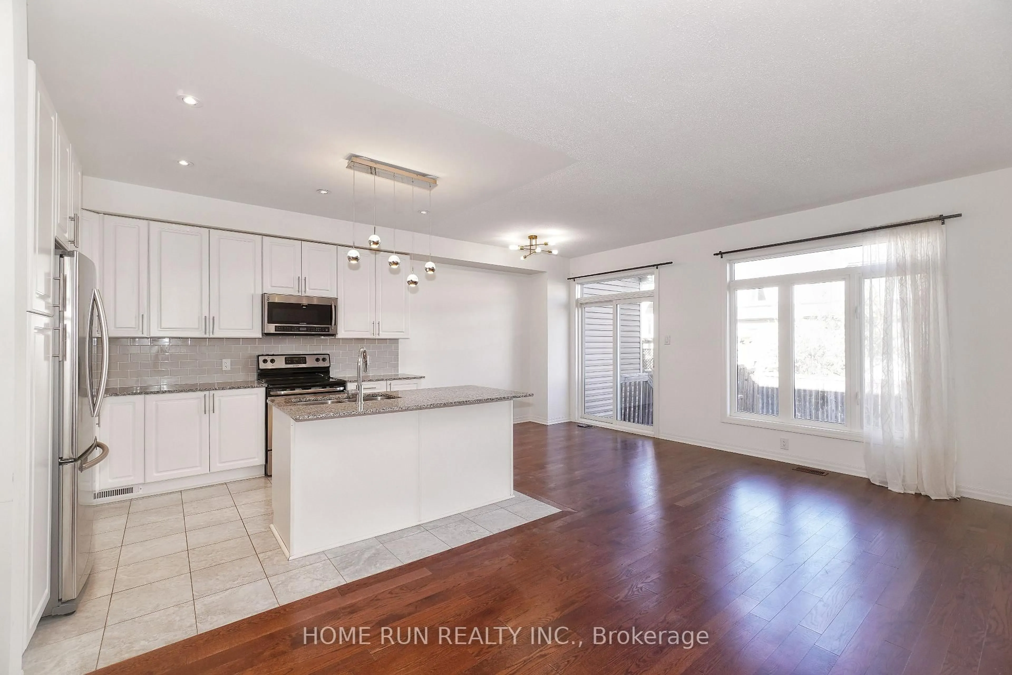 Open concept kitchen, wood/laminate floor for 118 Overberg Way, Ottawa Ontario K2S 0V9