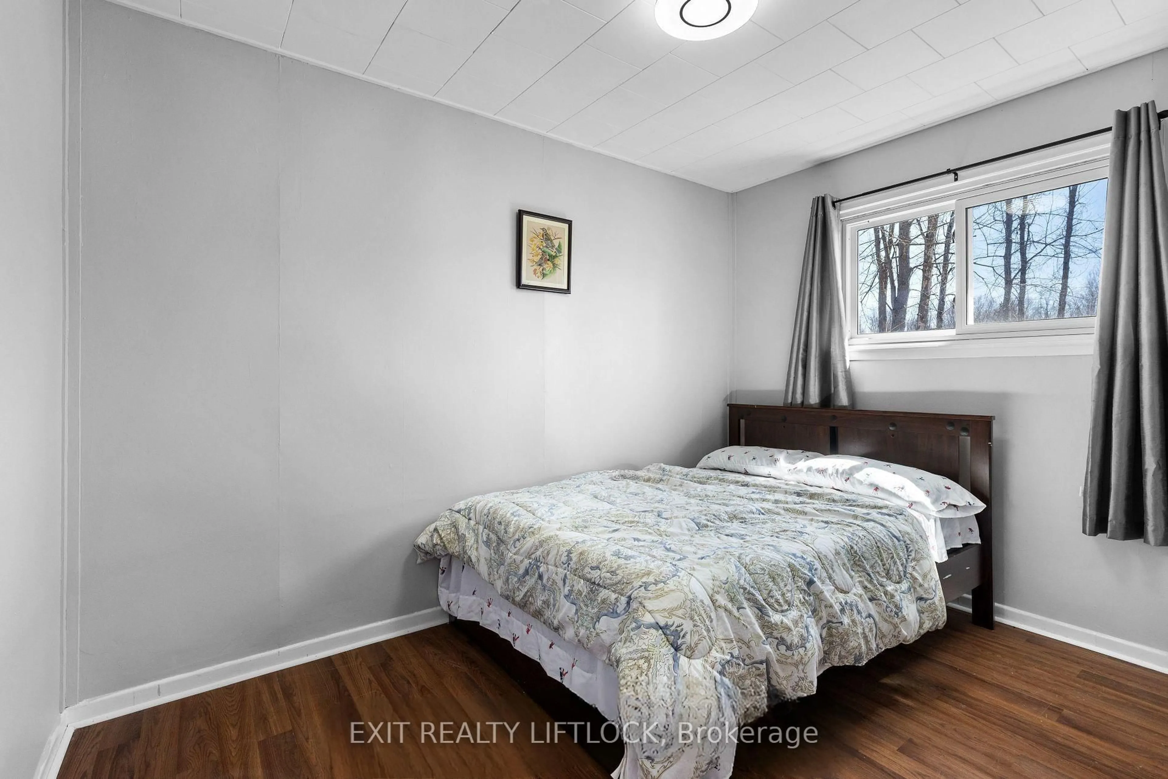 Bedroom with bed, wood/laminate floor for 31 River Rd, Trent Hills Ontario K0L 1L0