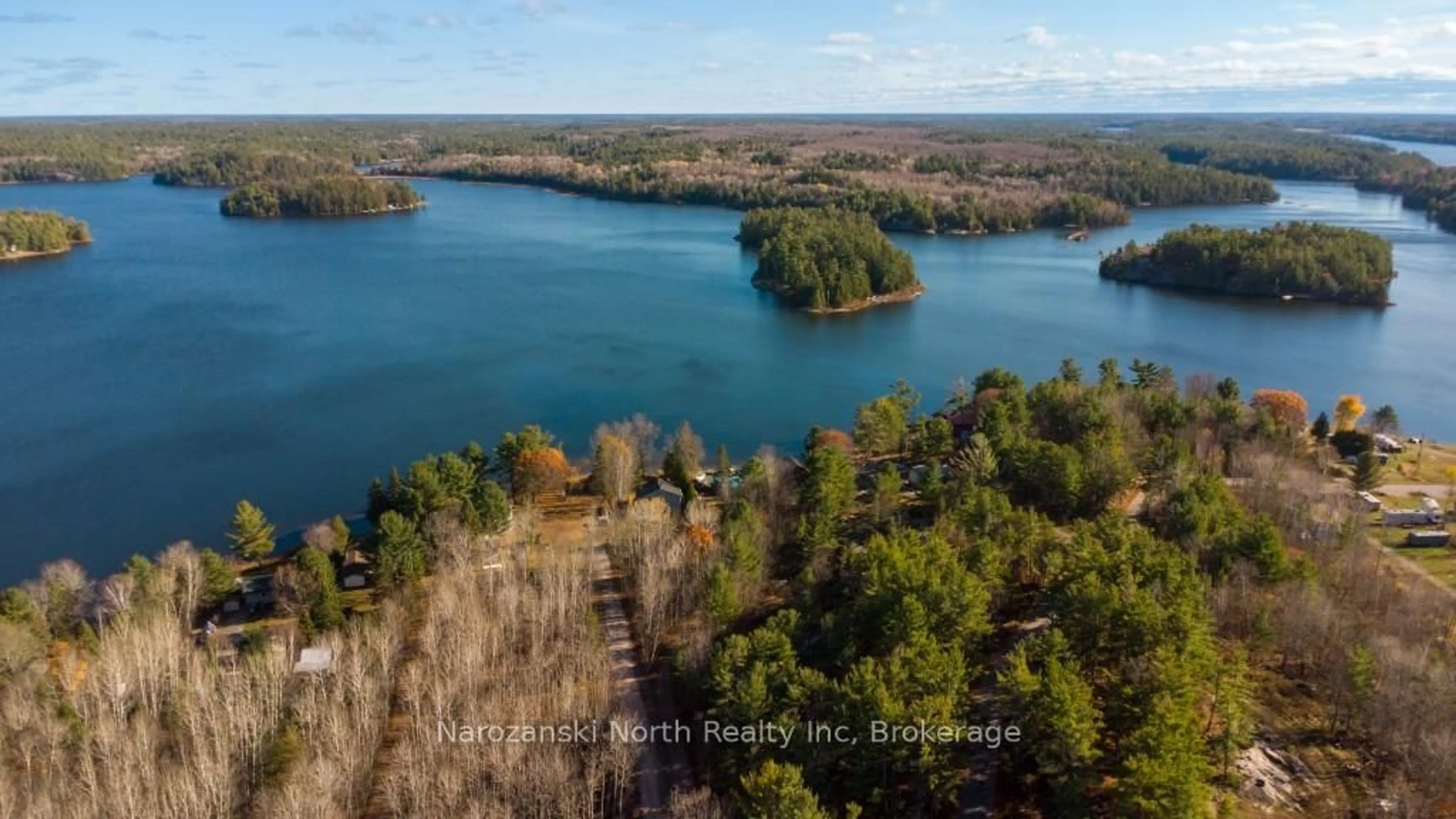 A pic from outside/outdoor area/front of a property/back of a property/a pic from drone, water/lake/river/ocean view for 100 C Whippoorwill Rd, French River Ontario P0M 1A0