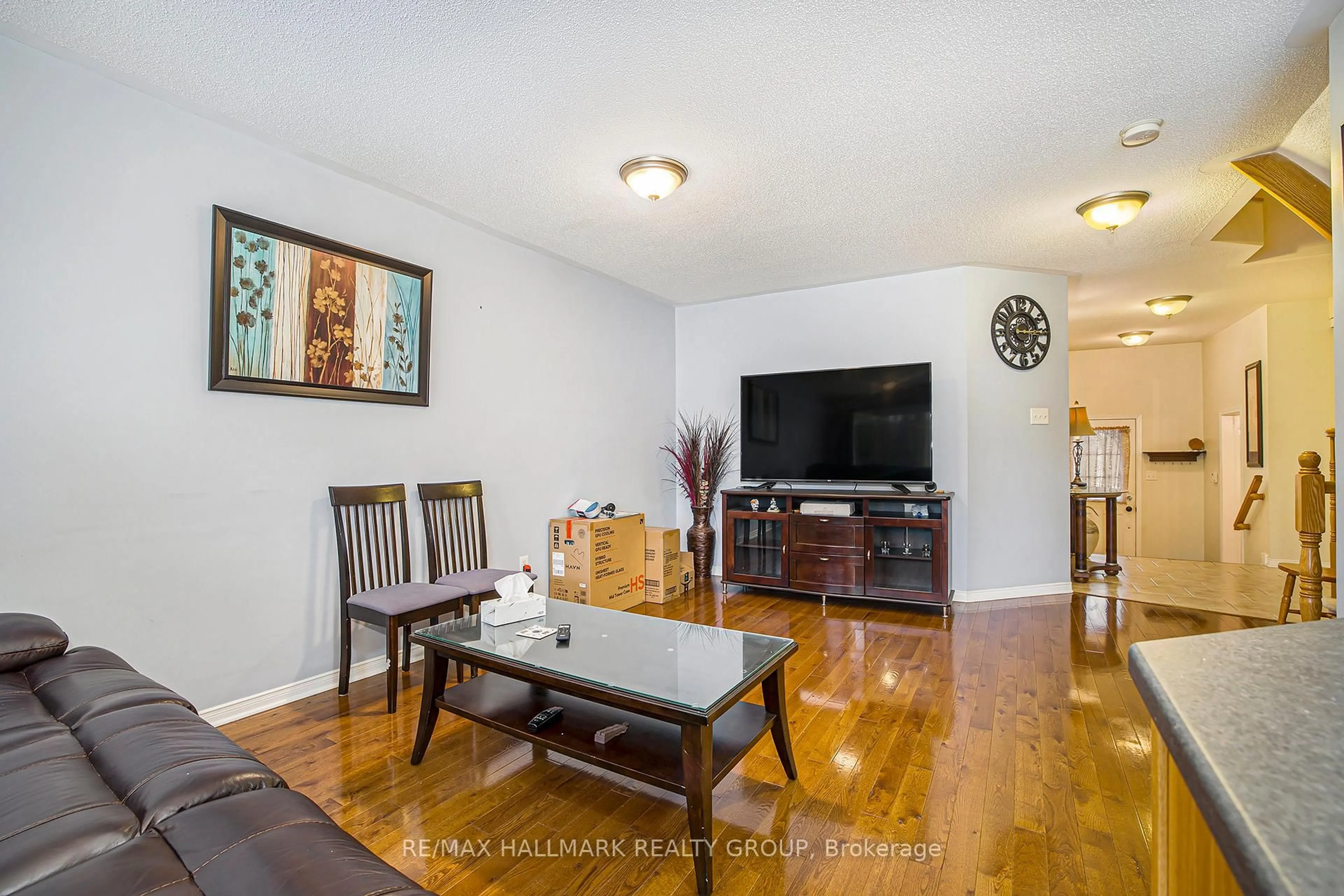 Living room with furniture, wood/laminate floor for 11 Scampton Dr, Kanata Ontario K2W 1G1