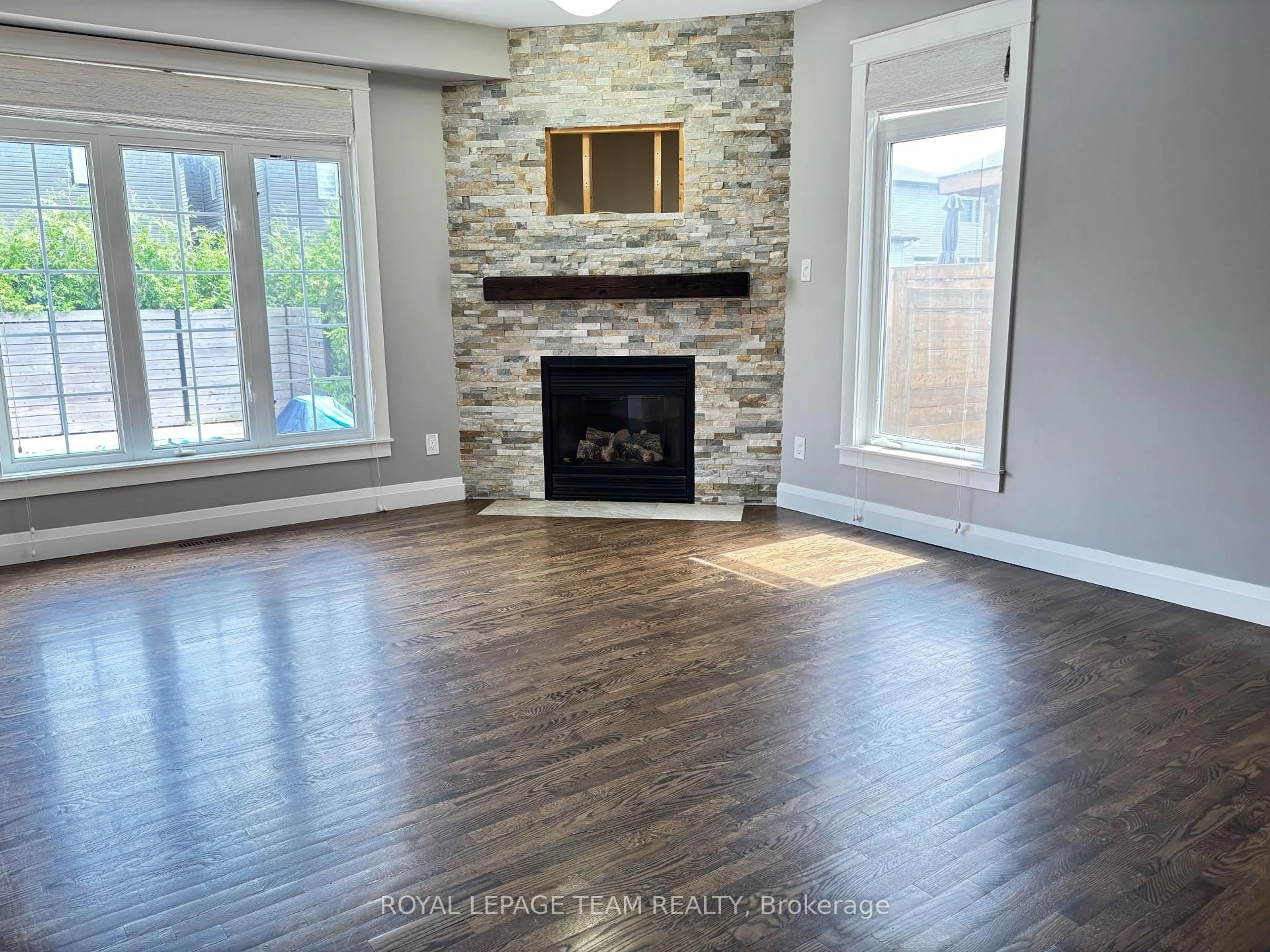 Living room with furniture, wood/laminate floor for 78 Friendly Cres, Stittsville Ontario K2S 2B5