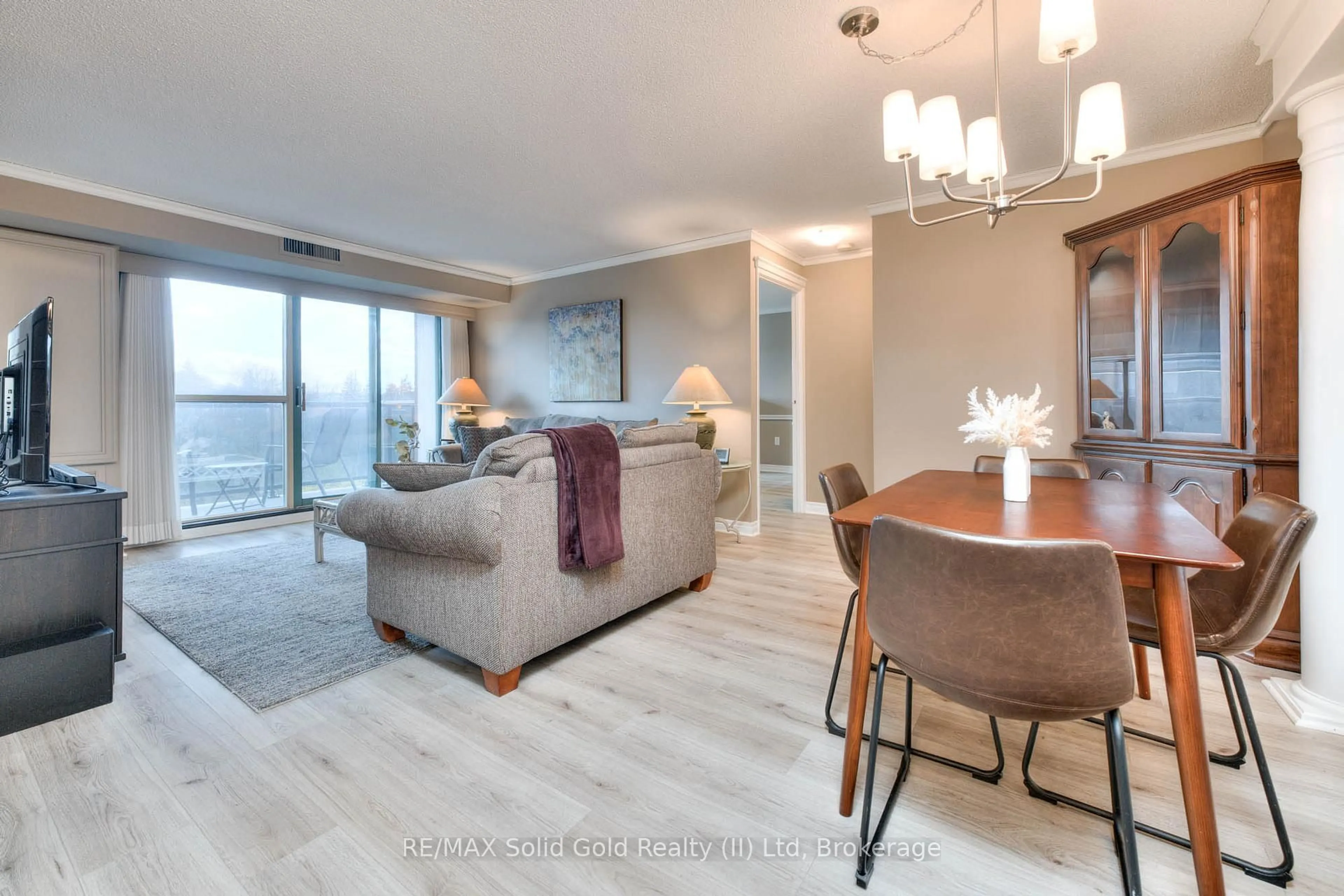 Living room with furniture, wood/laminate floor for 30 Blue Springs Dr #413, Waterloo Ontario N2J 4T2