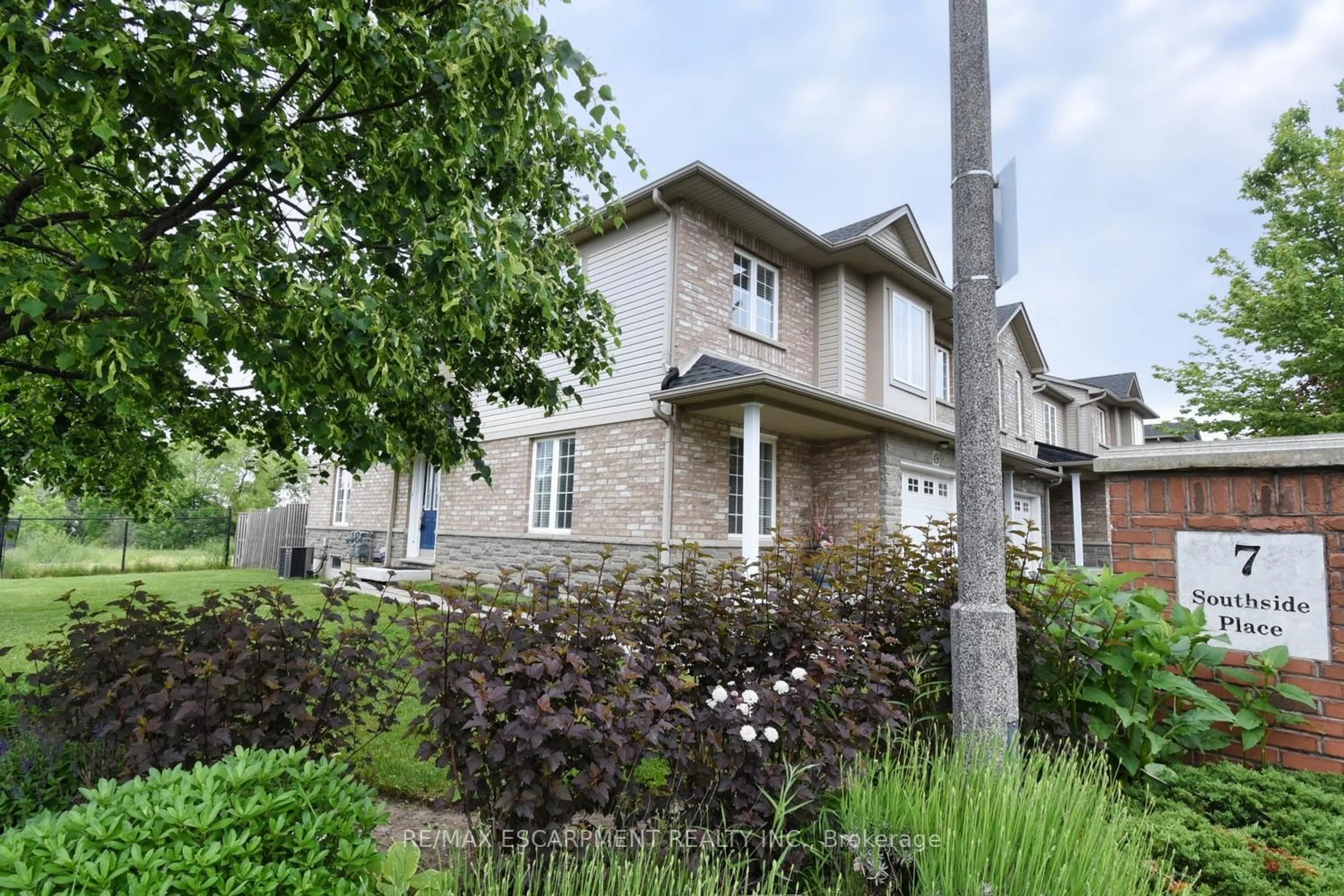 Home with brick exterior material, street for 7 Southside Pl #49, Hamilton Ontario L9C 7W6