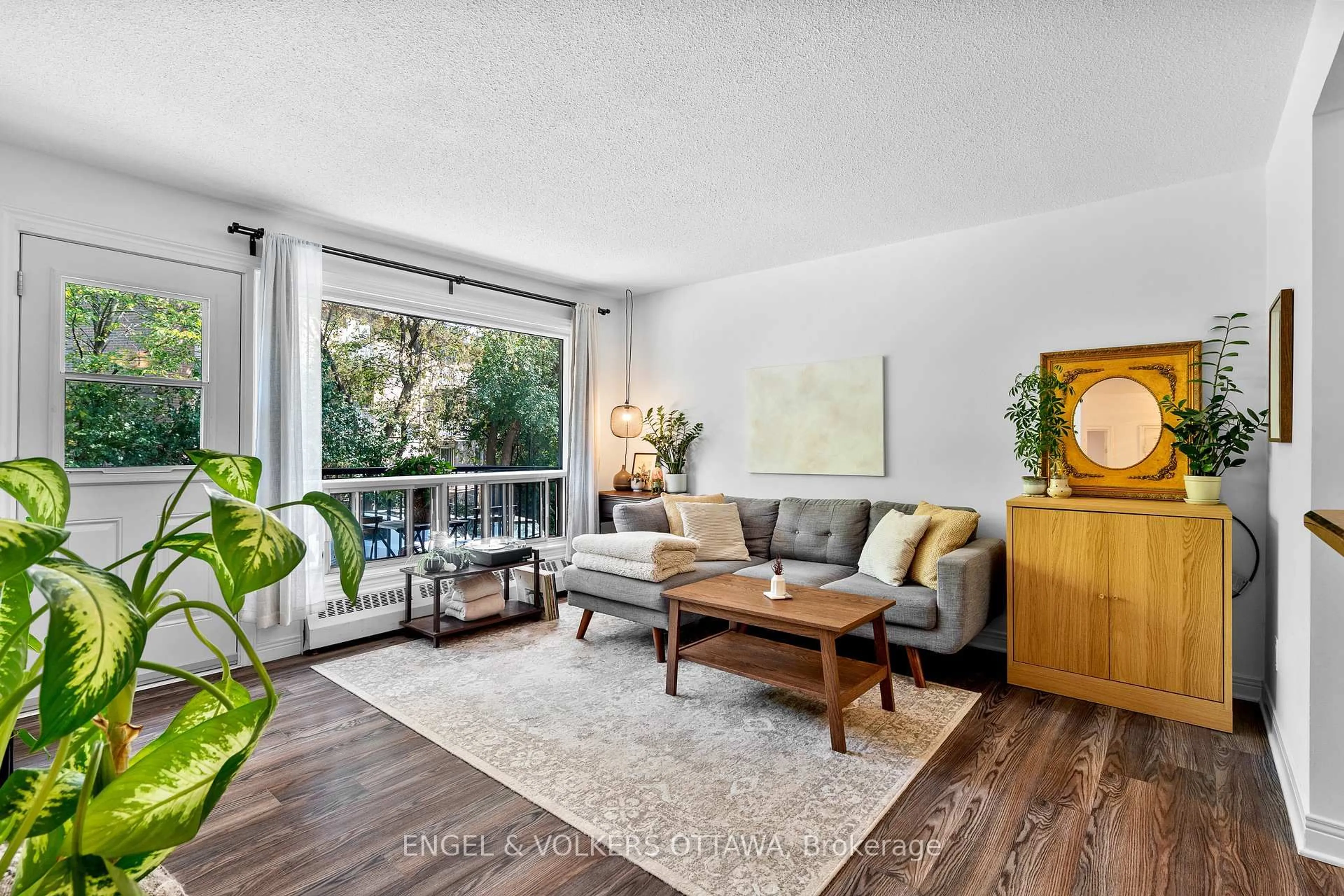Living room with furniture, wood/laminate floor for 270 Beechwood Ave #11, Ottawa Ontario K1L 8A6